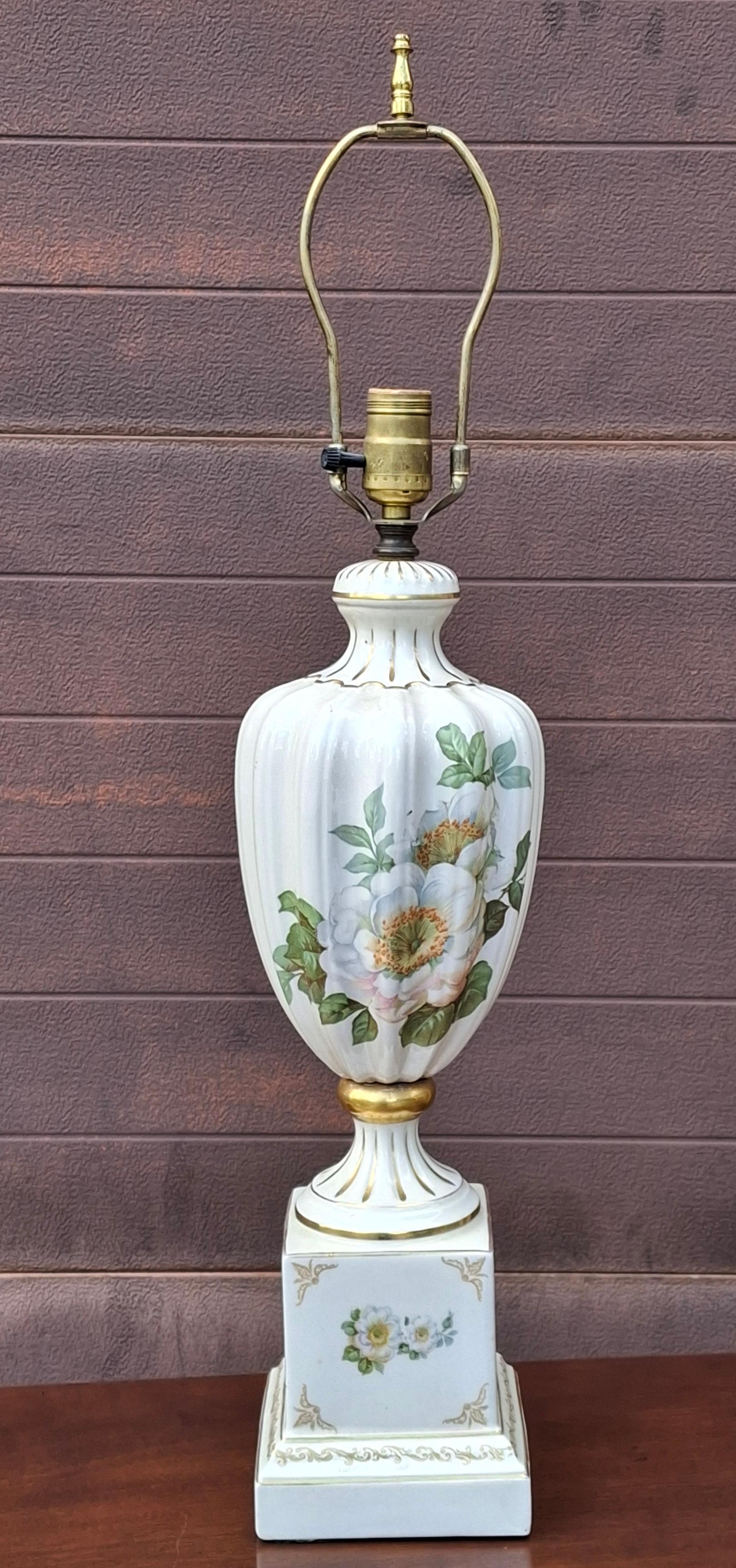 This is a vintage French hand-painted porcelain table lamp with a floral motif and gold gilt accents. 
Measures: 6