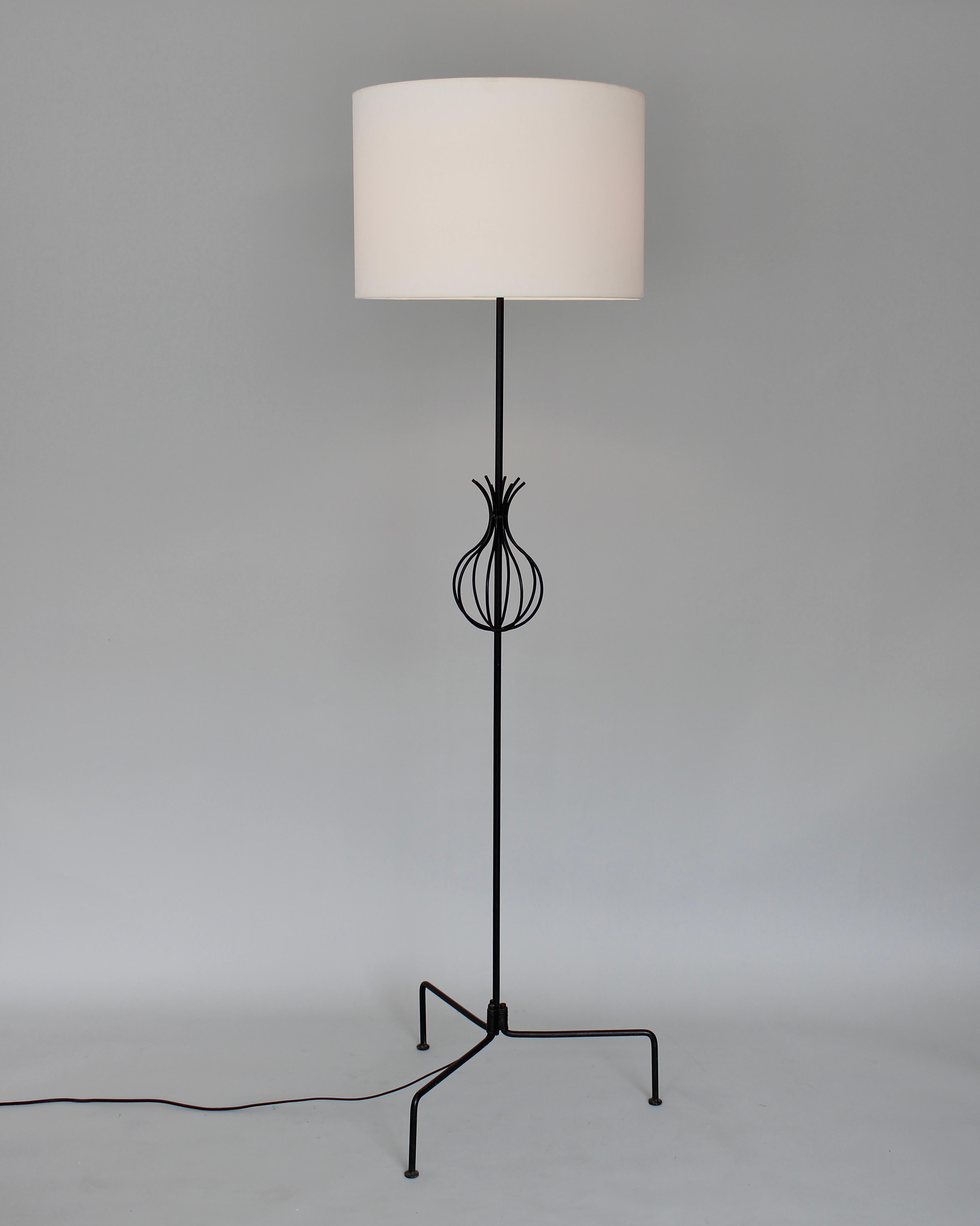 Interesting French floor lamp in black wrought iron with a pineapple or basket motif in the central portion on splayed legs. Very architectural. 
Attributed to Rene Jean Caillette, circa 1950
64