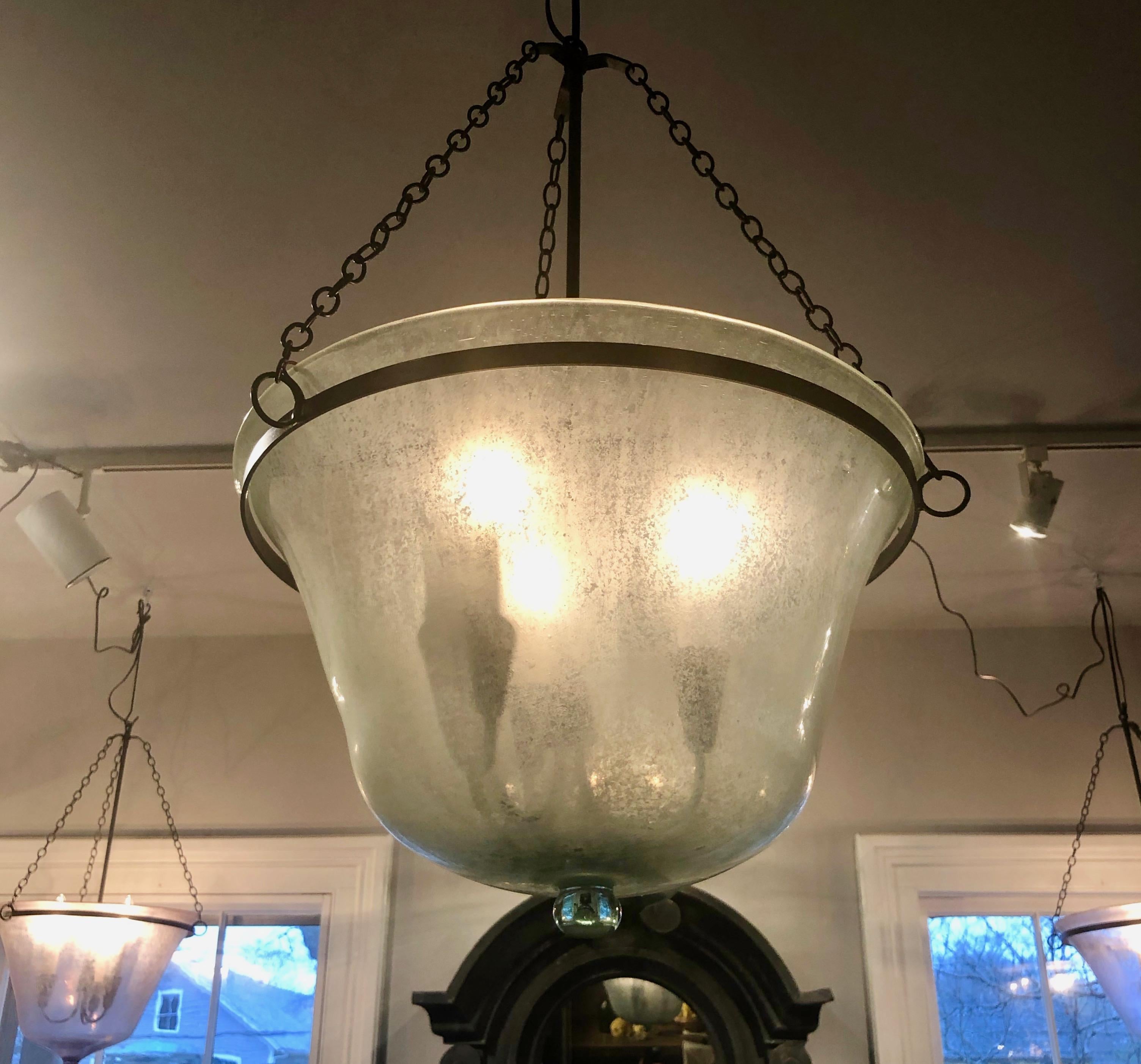 We have always had a thing for hand blown French garden cloches that come in two configurations, bell form and melon form. This one is a melon cloche (a little shorter and wider than a bell cloche) and it has been converted into a hanging light with