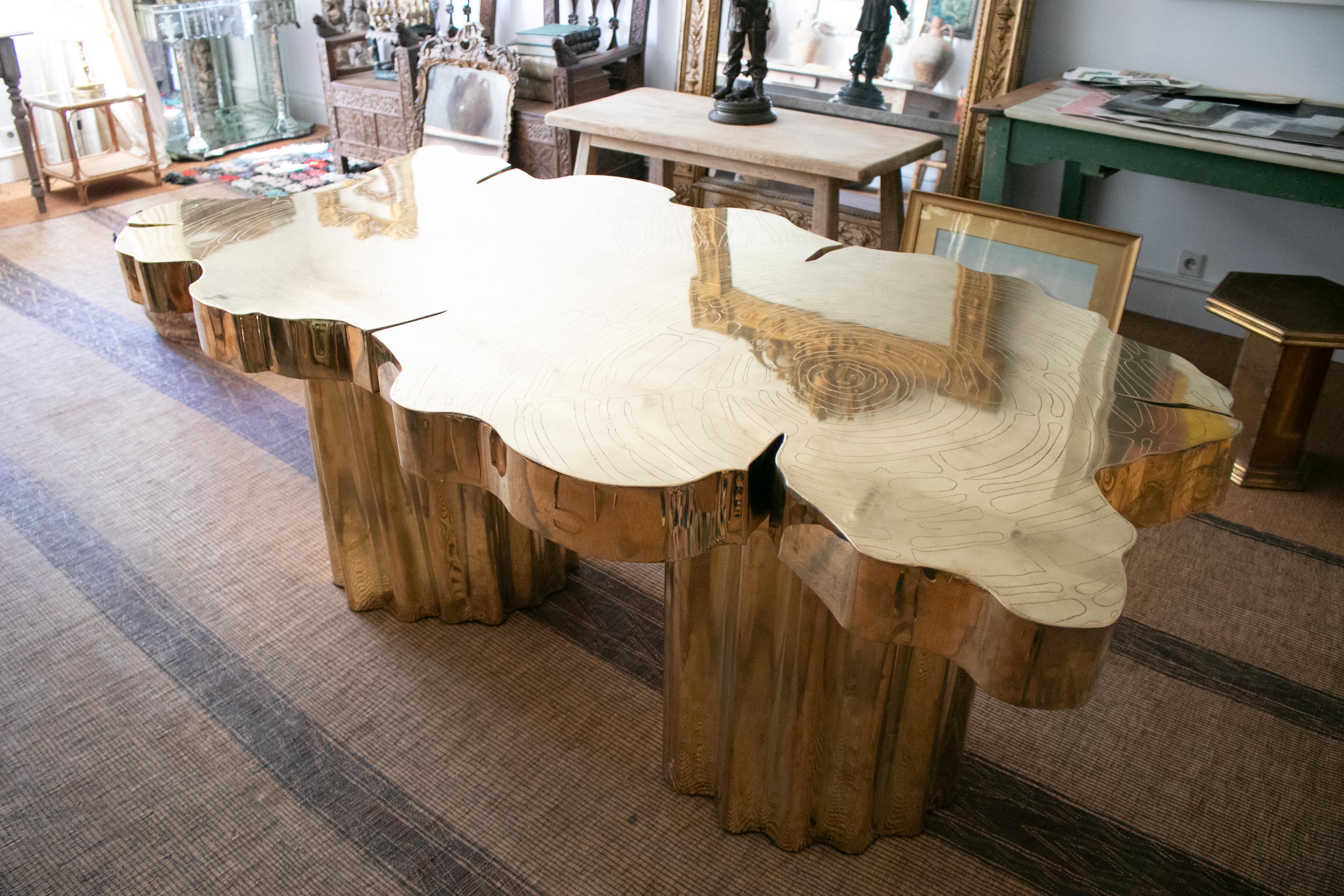 French handmade dining table made of bronze, the top is worked imitating a tree trunk, with two legs.