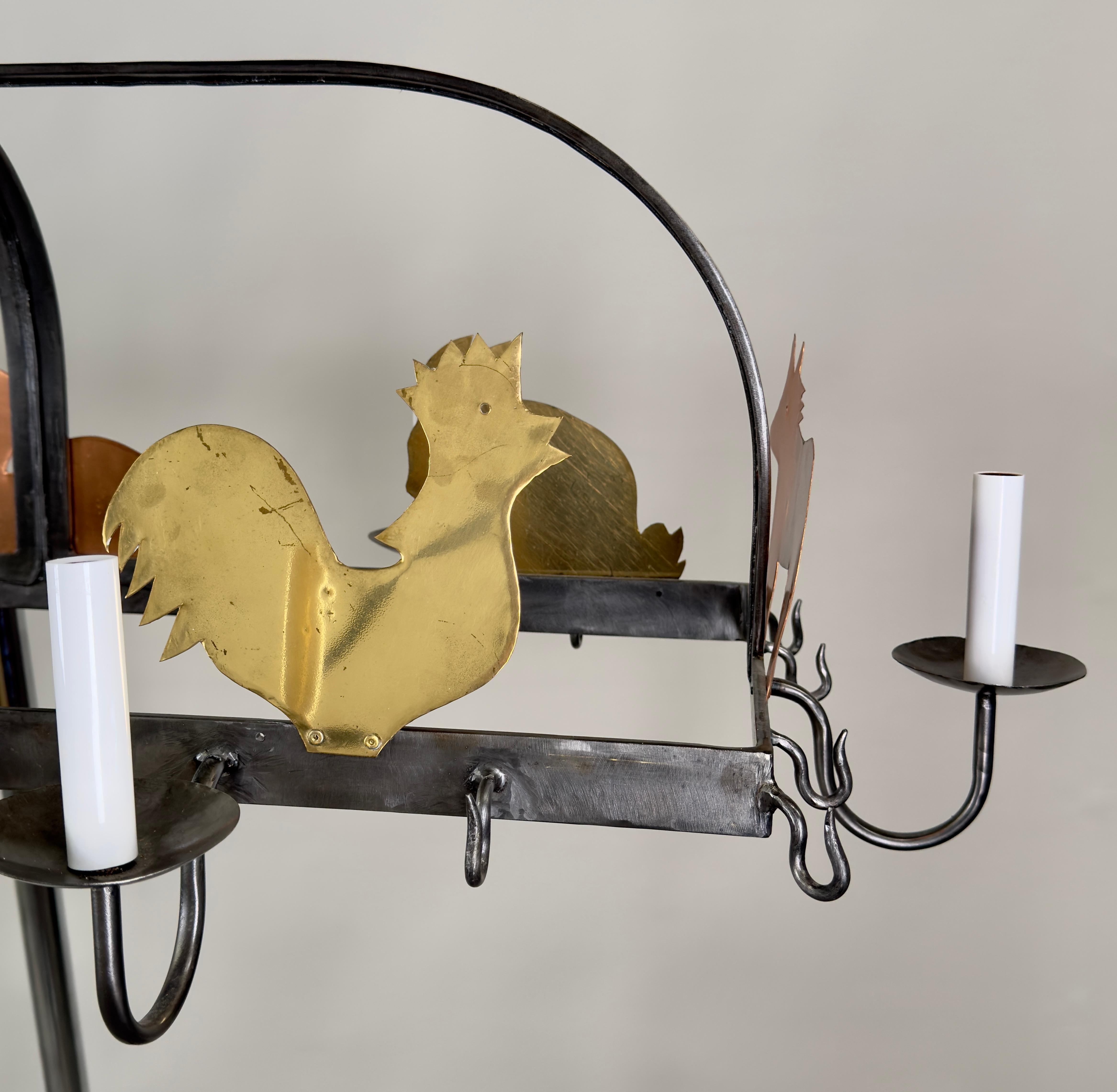 A vintage French hanging iron pot and pan holder with hooks pendant or chandelier , 10 arms. This  unique lighting fixture embodies a whimsical yet elegant design, expertly blending rustic charm with artistic flair. Suspended from two robust chains,