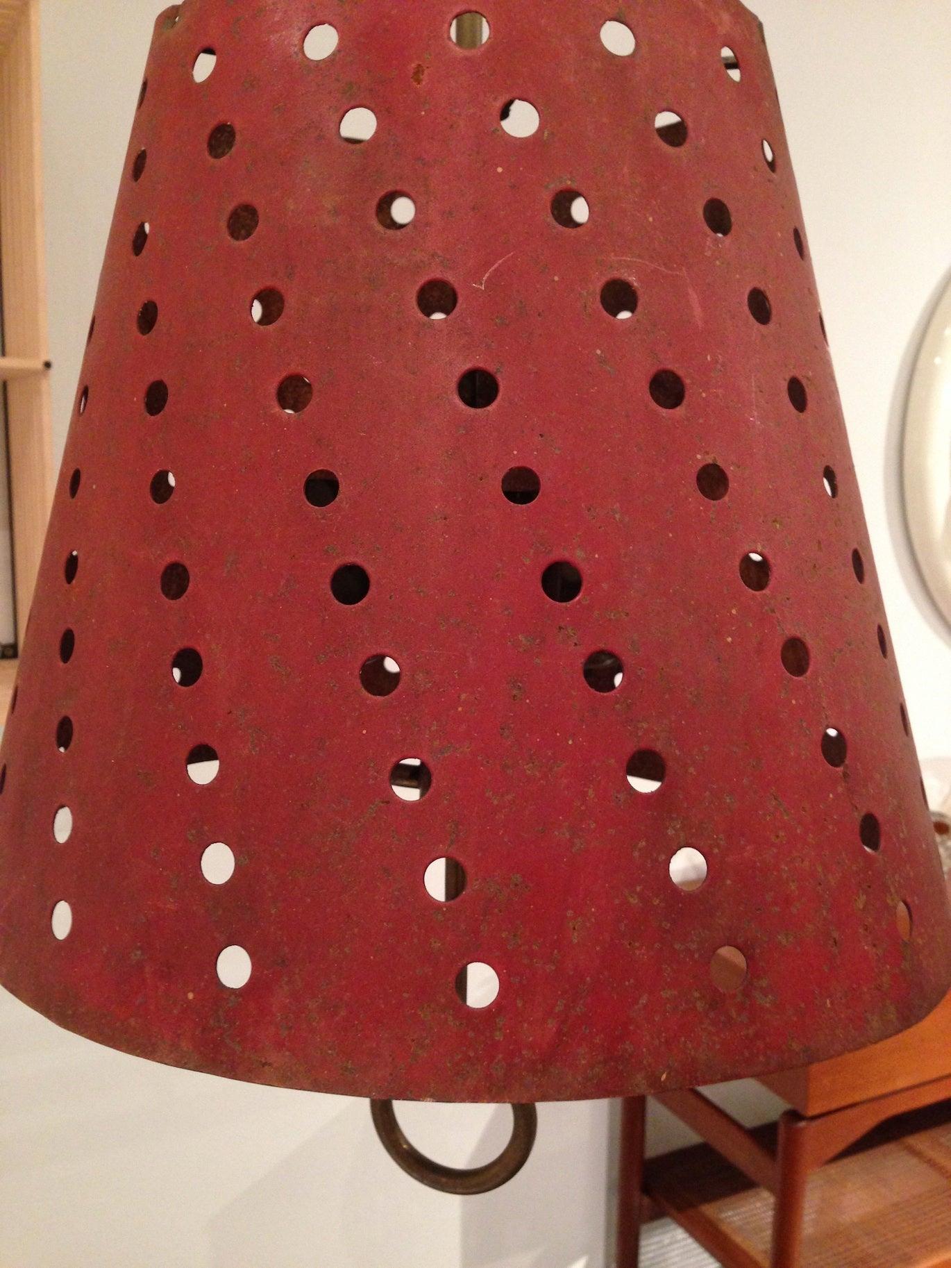 French midcentury hanging lamp in perforated steel shade in original red pain. Brass hanging hardware with ring motif, France, circa 1950s.