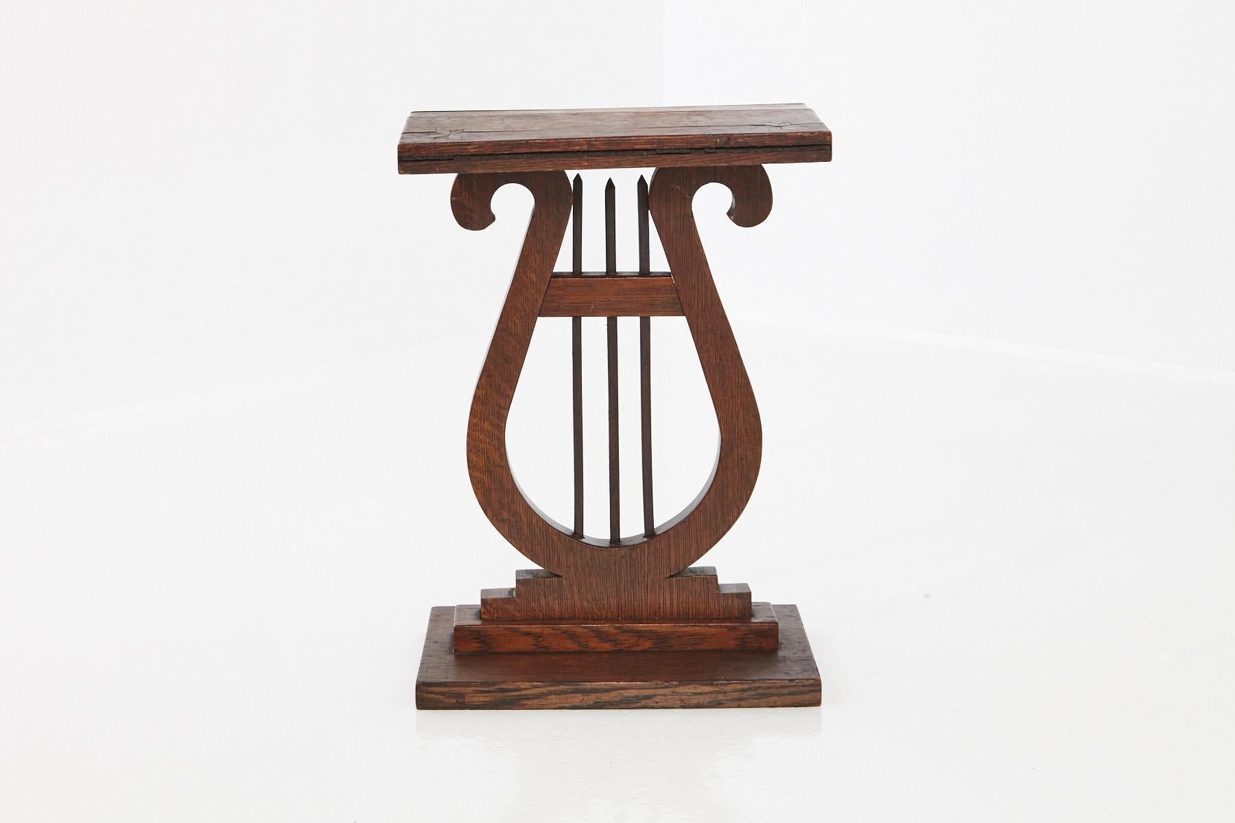 Late 19th century French harp or lyre style small side table, with carved starburst inlay at the corners of the top, circa 1880s. The top is warped, please refer to the photos.
The table has a very Wabi-Sabi style charm and patina.