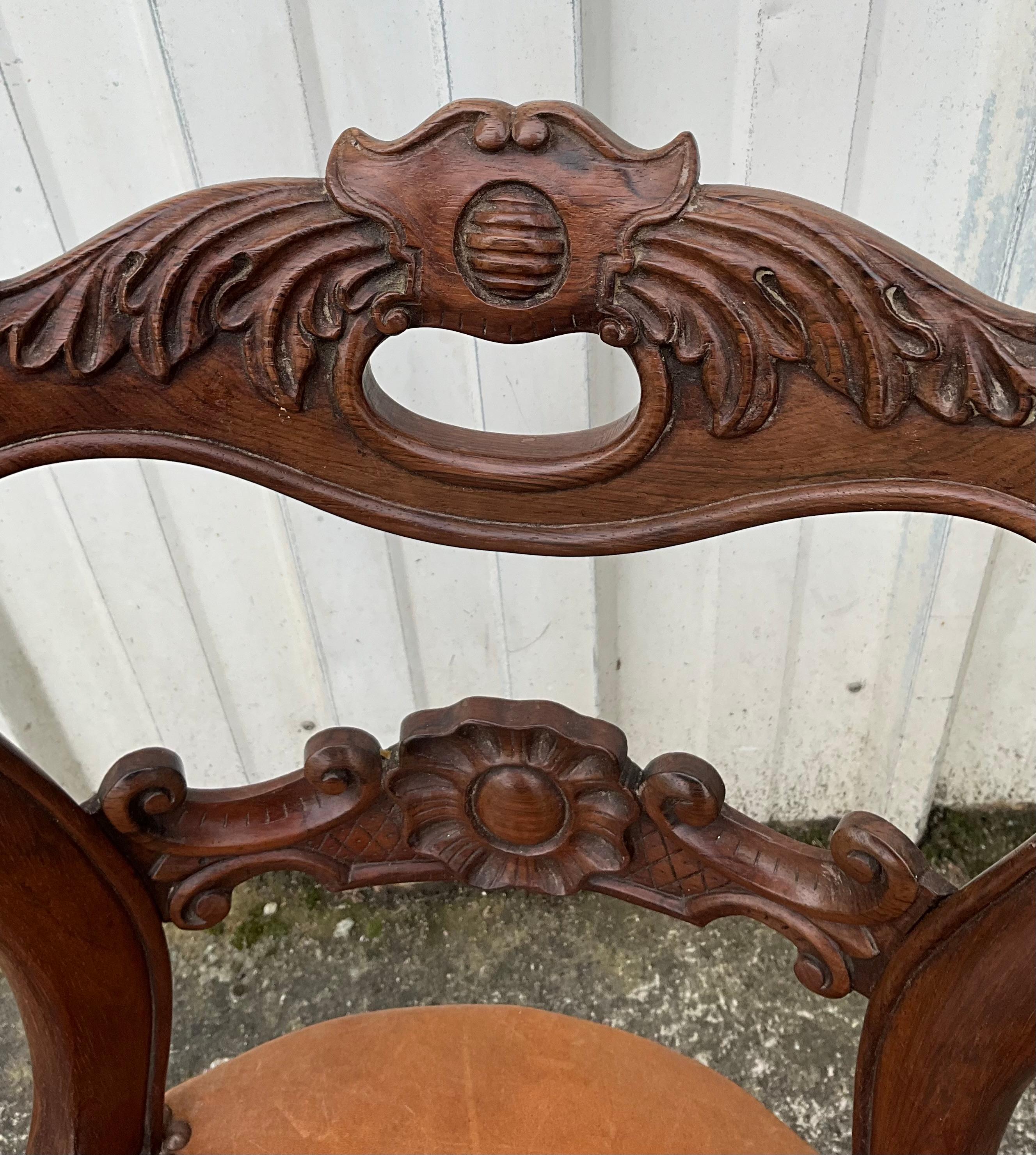 This harpist chair is made of solid rosewood. The seat is of very good quality and is covered with tan leather.

The height of the seat is adjusted using a metal screw in the leg of the chair.

The seat height at the lowest is 47 cm and at the