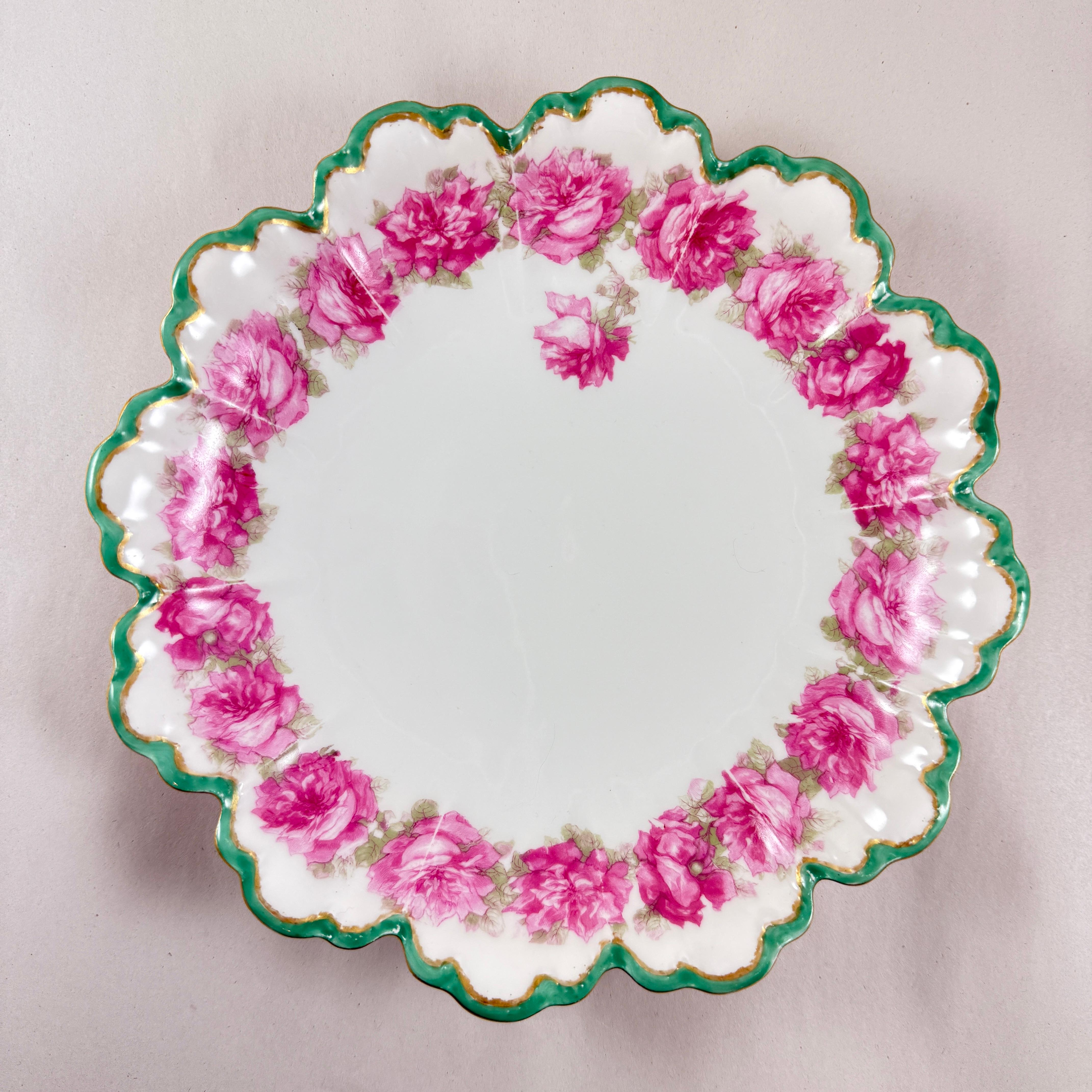 An unusual shaped porcelain bowl from Haviland Limoges, France – circa 1900.

Decorated by hand on both the front and back with running borders of Pink roses and green leaves.

The shaped petal influenced rim is bordered in a deep green and a gilded