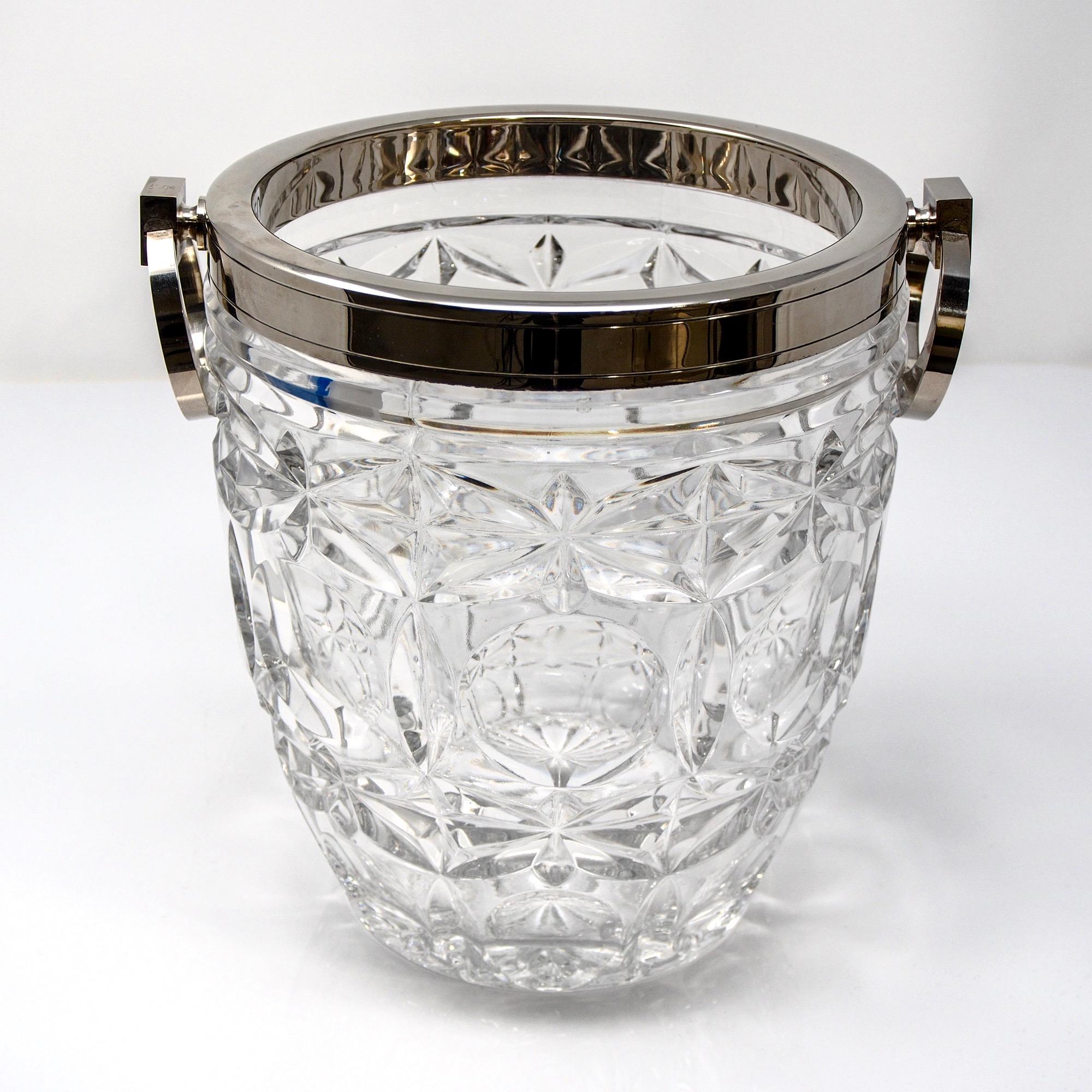 French crystal and sterling ice bucket, circa 1980s. Unknown maker but this is marked - see detail photo. Crystal body of vessel features a top and bottom band of starburst, with a middle band of ornamental cartouche cuts. Sterling rim and hinged