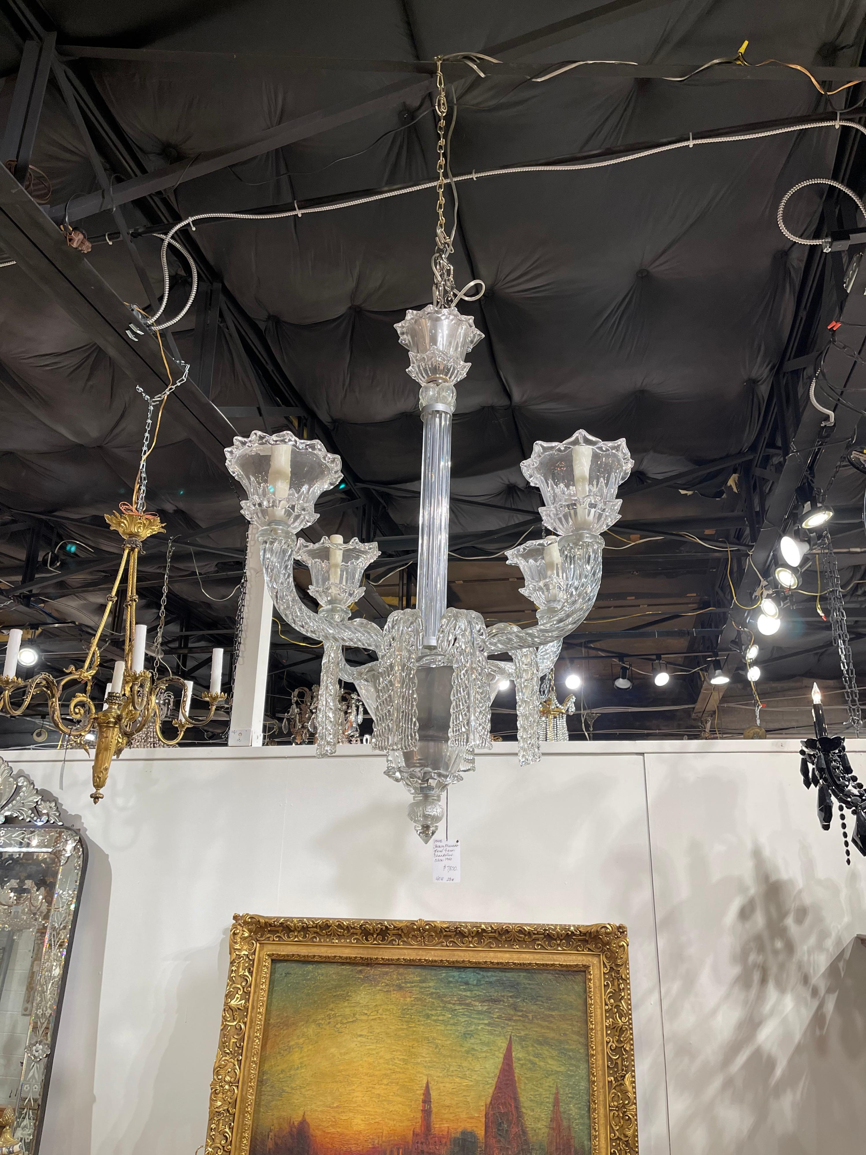 Superb French heavy cut glass chandelier with a star-point glass and chromium crown atop a swirl patterned cut glass stem. The chromium bowl-shaped mid-section mounted with cut glass drapes and four curved arms having cut glass candle cups. Accented