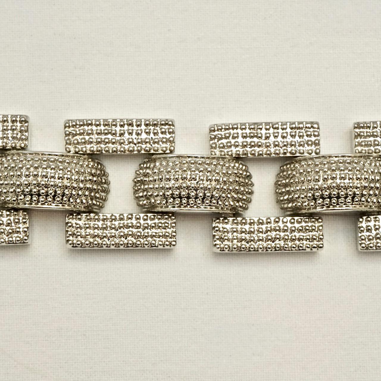 French heavy silver tone tank style link bracelet, featuring raised dome decoration. Length 17.5cm / 6.9 inches by width 2.15cm / .84 inch. The bracelet is in very good condition, with scratching as expected.

This is a wonderful silver tone