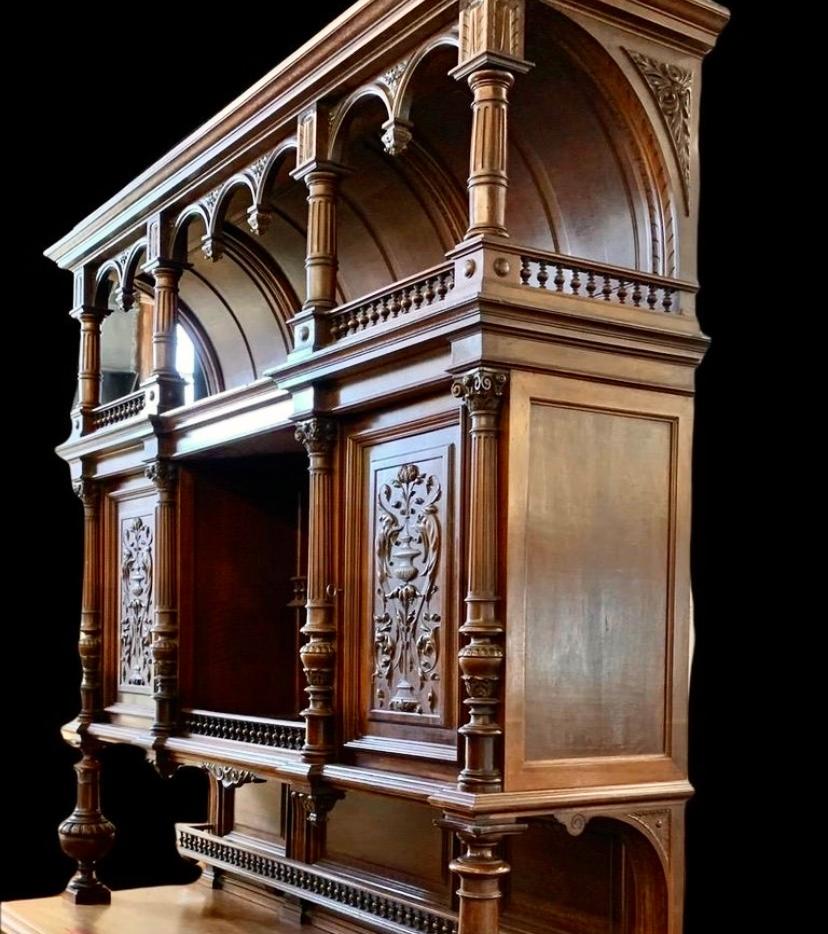 French Henri II Style Carved Walnut
Buffet a Deux Corps, c. 1880, the stepped crown over an arched breakfront top with spindle galleries below, on a setback breakfront center with two spindled plate racks flanked by cupboard doors, on turned tapered