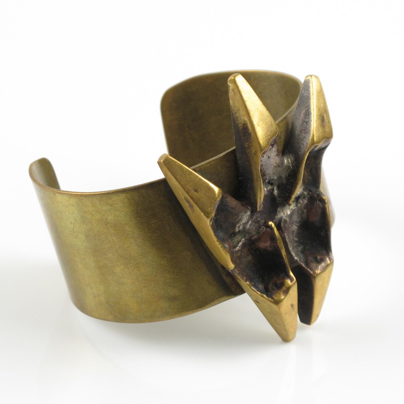 Impressive sculptural brutalist bronze cuff bracelet by French sculptor and painter, Henri Nogaret (1927 -). The large bronze band is topped with a modernist abstract sculpture ornament. Signature engraved on the side.
Please check our storefront,