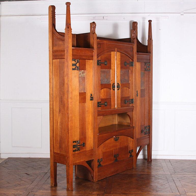 Absolutely stunning and unique French Arts and Crafts cabinet by Henri Rapin, a prominent French designer of the period. Constructed in solid quarter-sawn oak, this massive piece features panelled doors with bold hammered metalwork and embossed