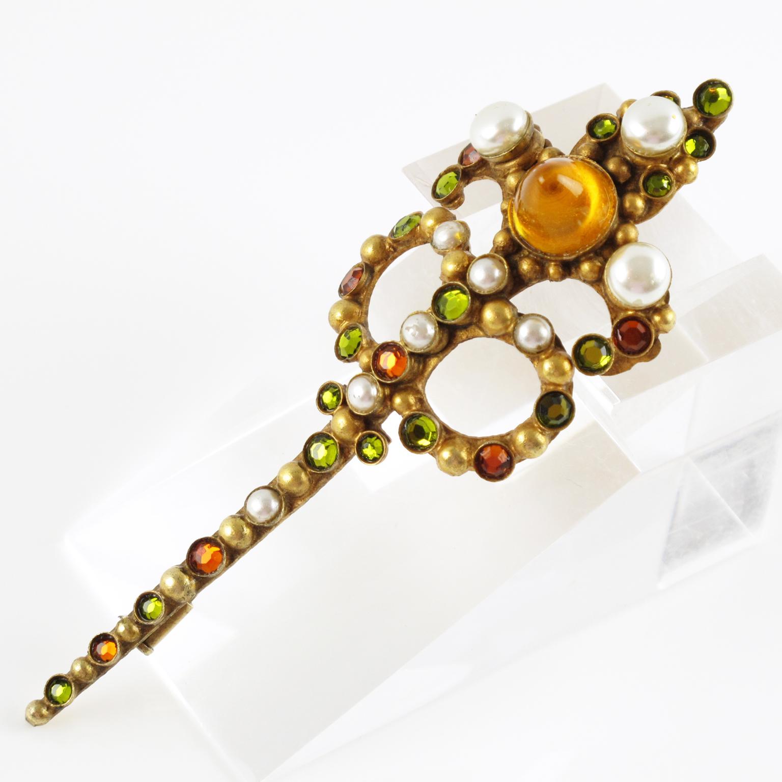 Beautiful French jewelry designer Henry Perichon (also known as Henry) extra long gilt bronze pin brooch. An elongated shape in a Renaissance design influences ornate with simulated pearls, colorful poured glass cabochons, and crystal stones. The