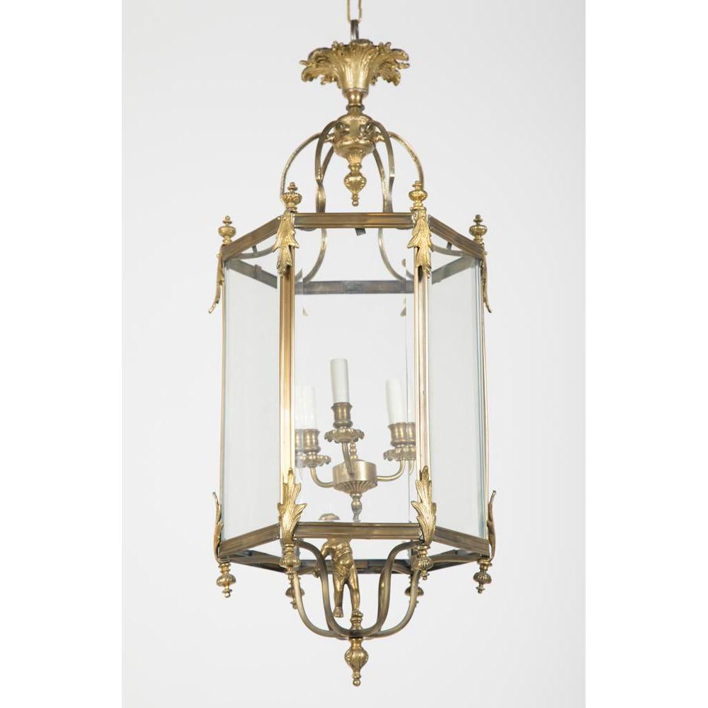 French bronze hexagonal three-light hall lantern with a putti figure holding the central light cluster.