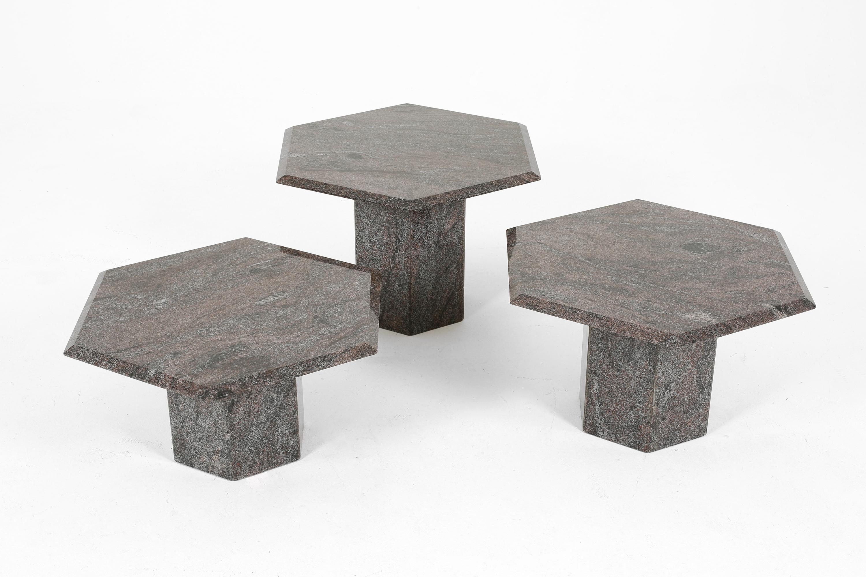 A set of three graphic hexagonal granite stone side/coffee tables, graduating in height with bevelled edges. Dark grey and white, with hues of pink running throughout. French, c. 1980s.

Tall: D69 x H43.5 cm

Medium: D69 x H38.5 cm

Short: D69