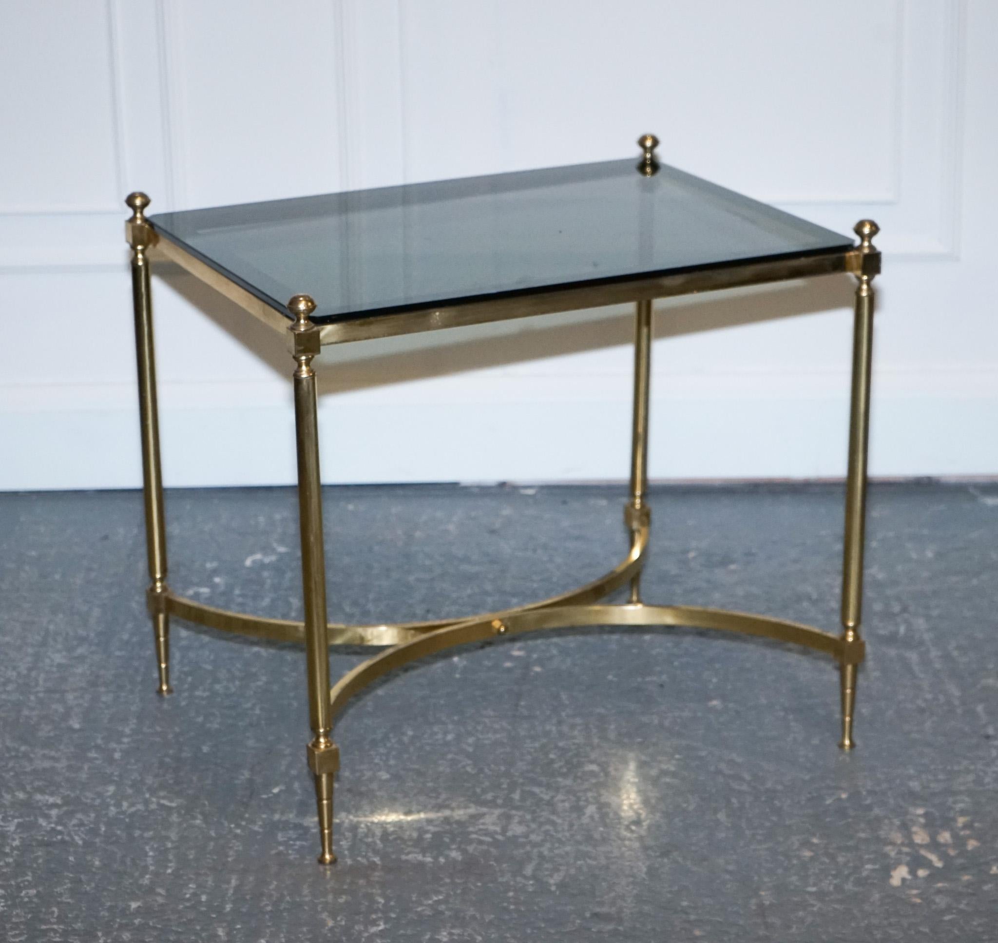 We are delighted to offer for sale this Hollywood Regency Brass & Smoked Glass Coffee Table.

A French Hollywood Regency 1960s brass and smoked glass coffee table is a truly stunning and luxurious piece of furniture. This coffee table is crafted