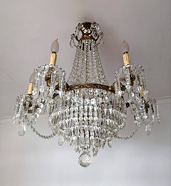 Lampadario a 12 luci Hollywood Regency Empire in bronzo dorato con ghirlande di cristallo