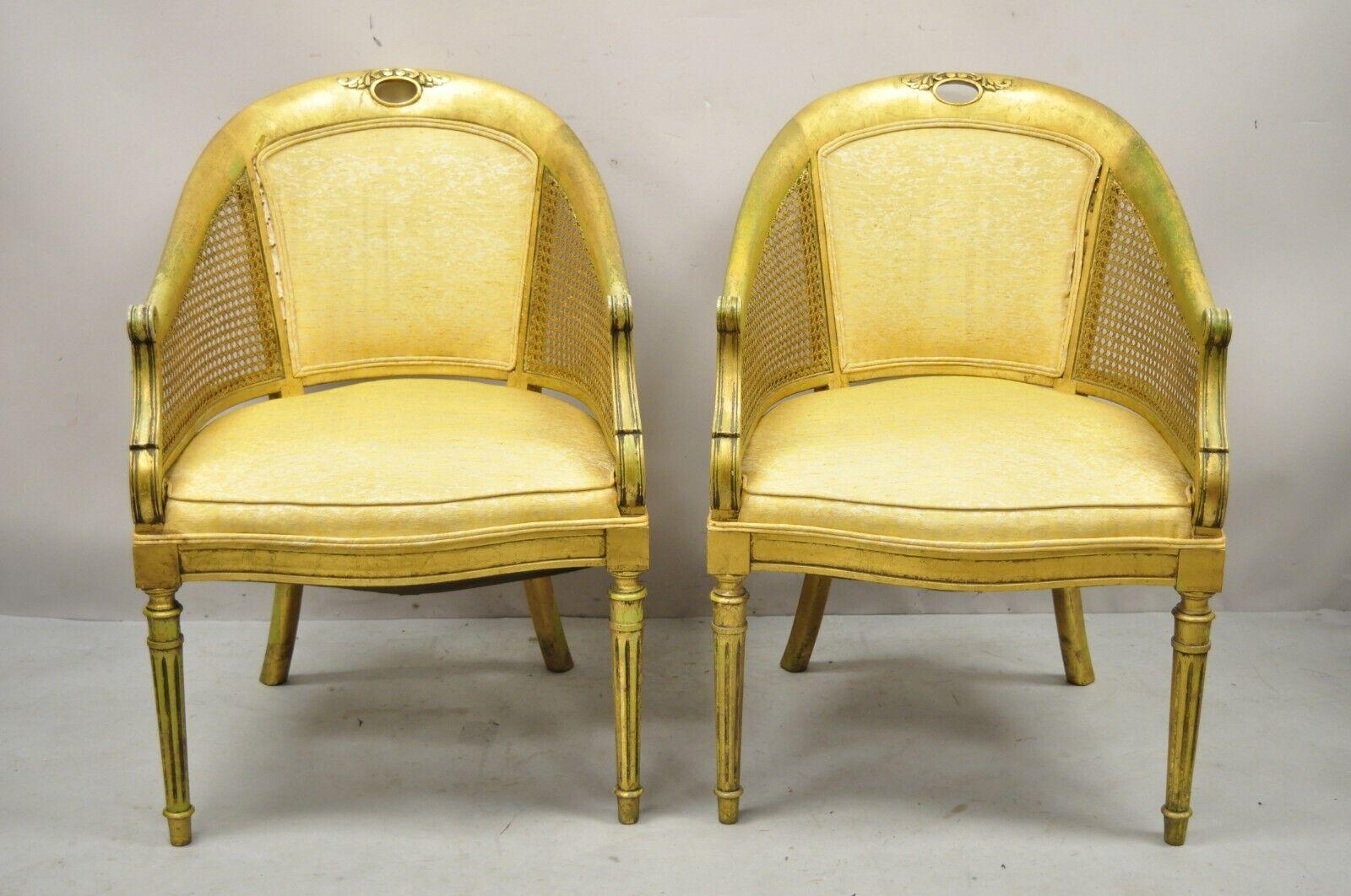 Vintage French Hollywood Regency gold gilt barrel back cane lounge chairs - a pair. Item features cane arm panels, solid wood frames, distressed finish, tapered legs, very nice vintage pair, great style and form. Circa mid-20th