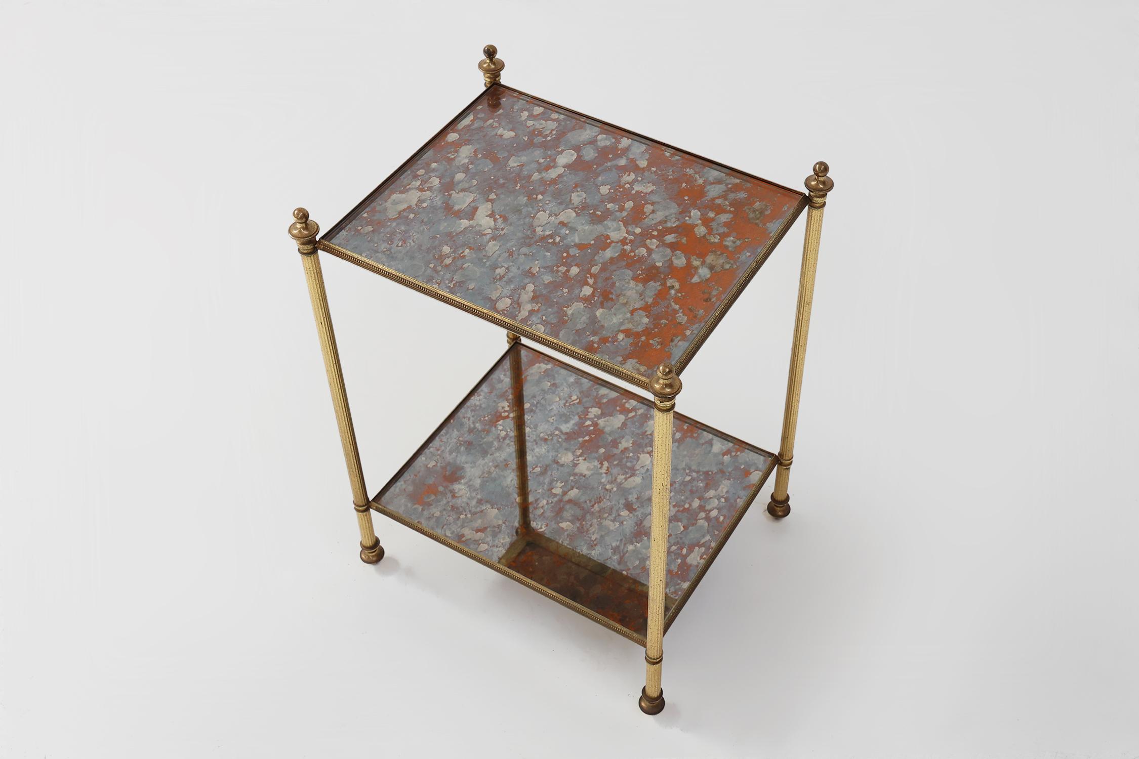 France / 1960 / side table / brass, smoked glass / Hollywood Regency / Mid-century / Vintage

Beautiful two tier brass side or end table with eglomised glass by Maison Jansen. Both mirrored tops have a delicate beaded frames. In excellent condition