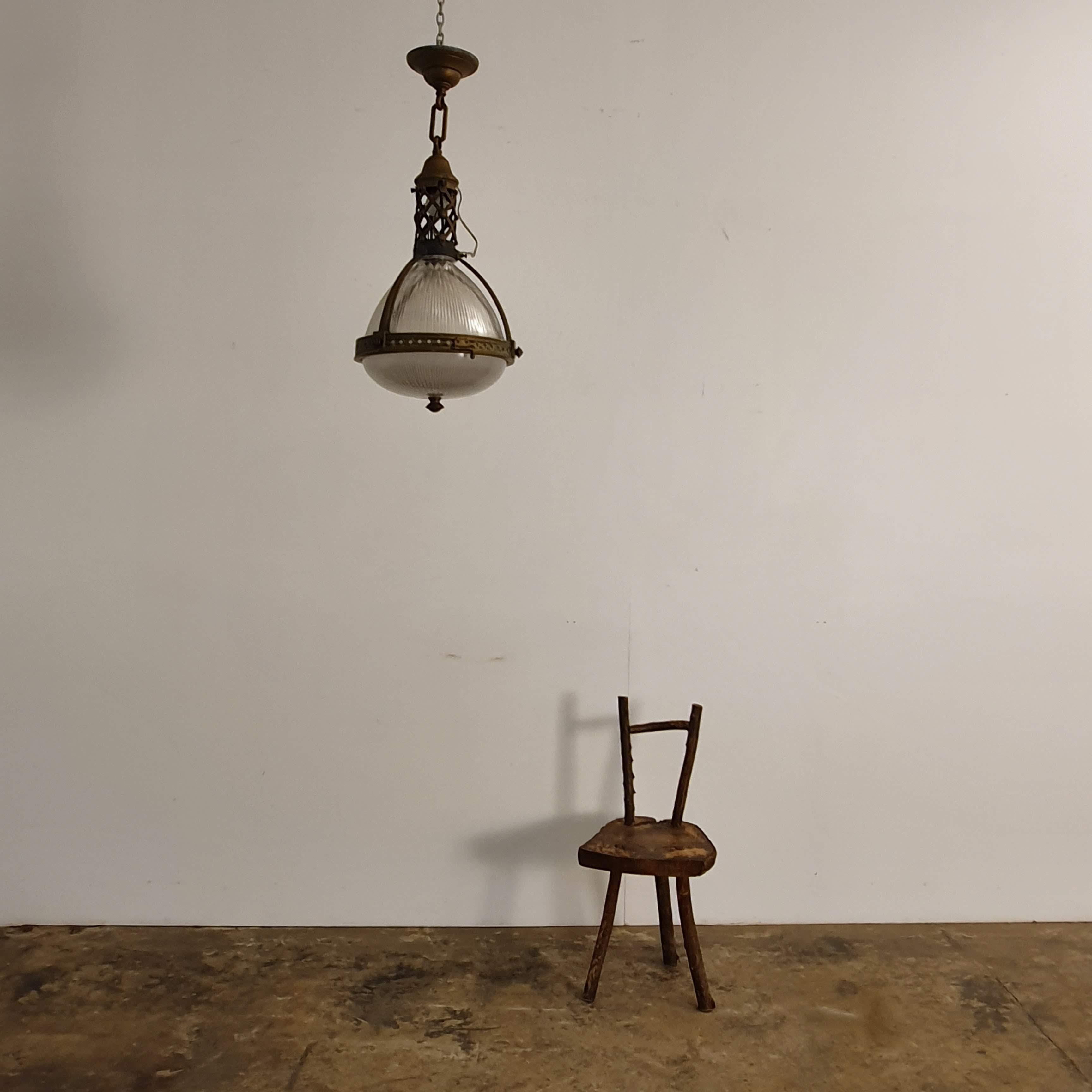 Original French industrial holophane pendant light, in brass and glass.