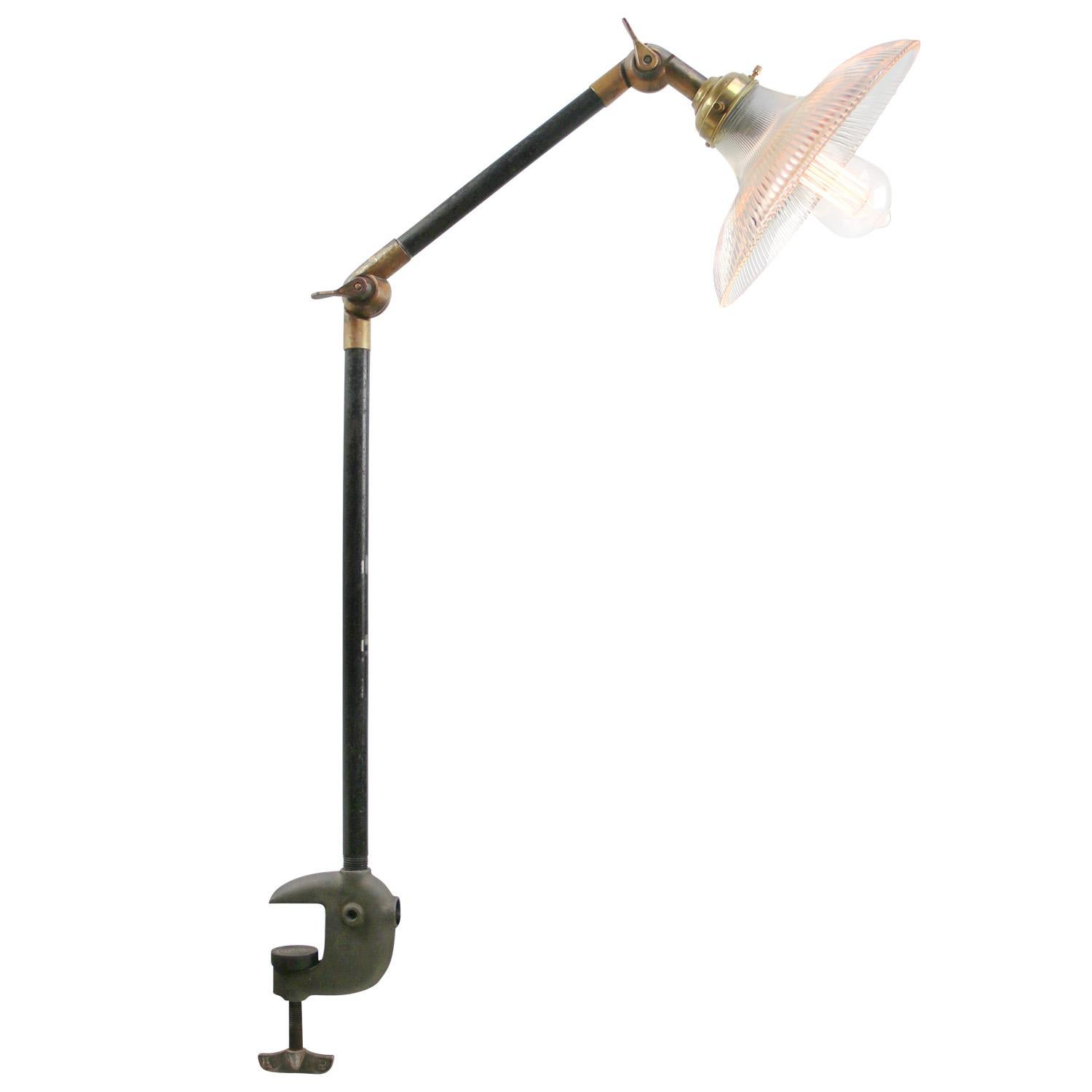 French Holophane Glass Vintage industrial 2-arm machinist work table lamp
Cast iron clamp and arm. Brass joints.
Adjustable in height and angle.
Including plug and switch

Available with UK / US plug

Weight: 3.30 kg / 7.3 lb

Priced per individual