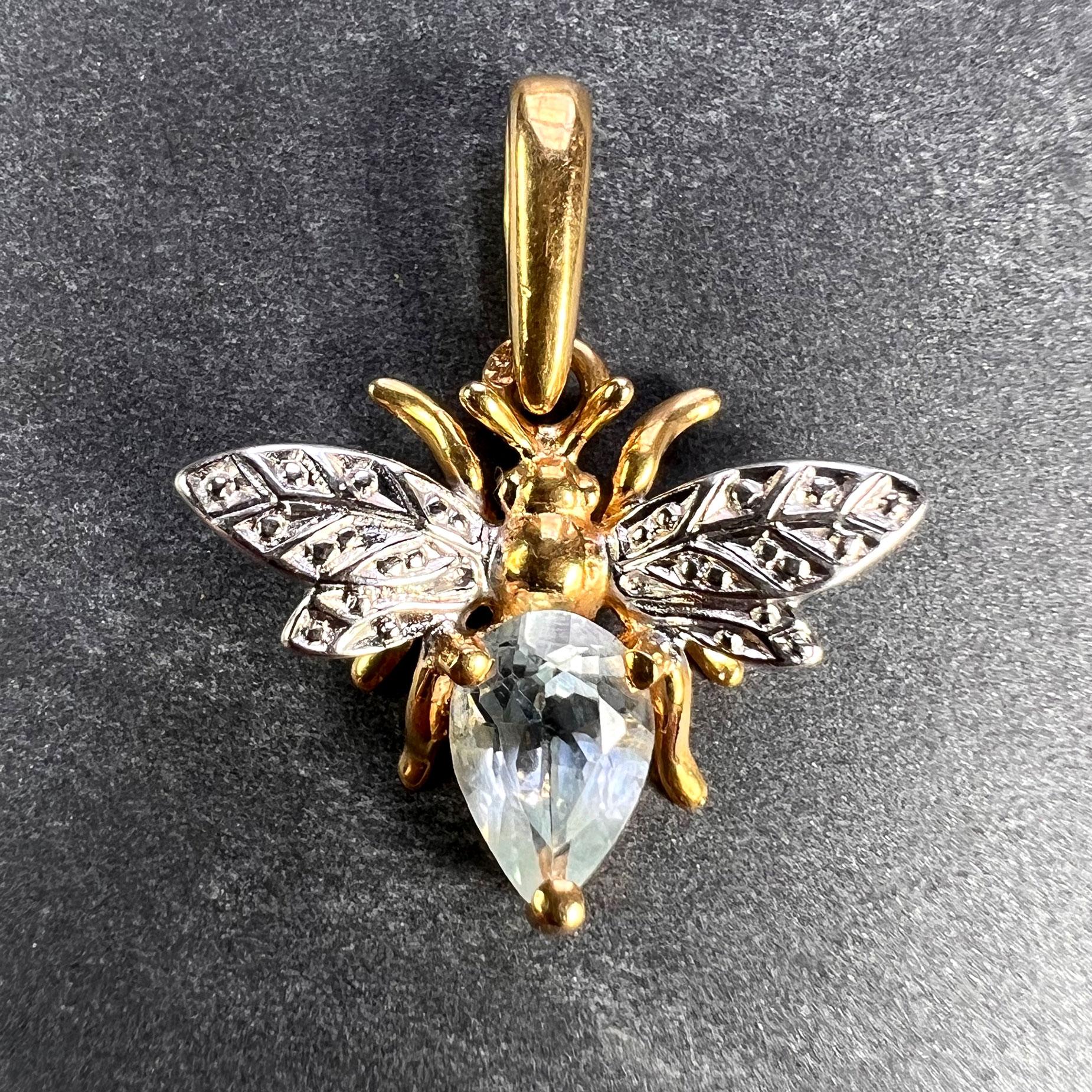 A French 18 karat (18K) yellow and white gold charm pendant designed as a honey bee set with a pear-shaped aquamarine weighing approximately 0.43 carats to the body. Stamped with the eagle’s head mark for 18 karat gold and French manufacture, and an