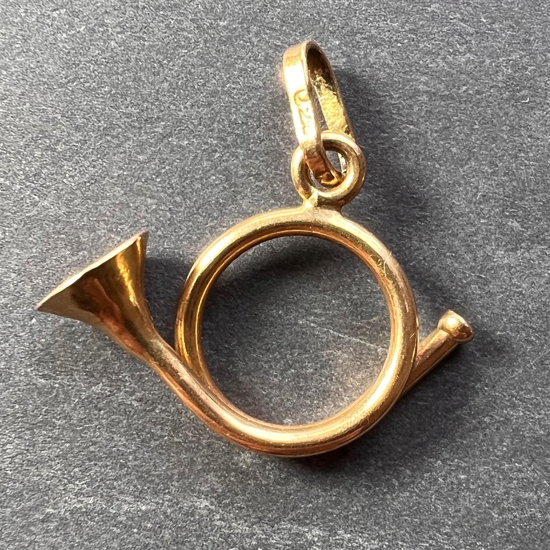 An 18 karat (18K) yellow gold charm pendant designed as a French horn. Stamped 750 for 18 karat gold to the bail.
 
Dimensions: 1.6 x 2 x 0.6 cm (not including jump ring)
Weight: 1.75 grams
