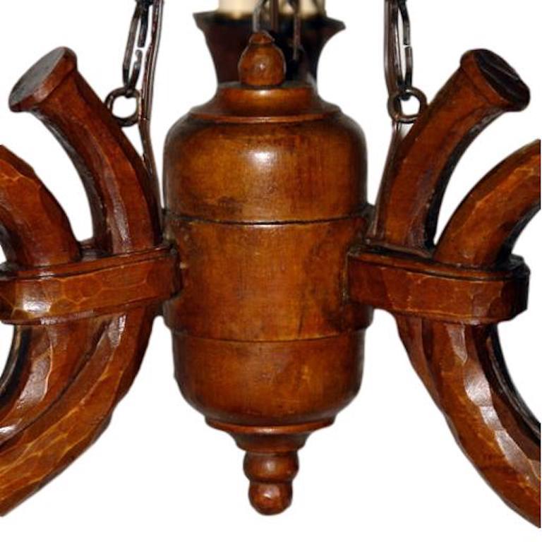 A circa 1920's French chandelier in carved wood in the shape of three hunting horns with a total of nine lights.
Measurements:
Height: 27
