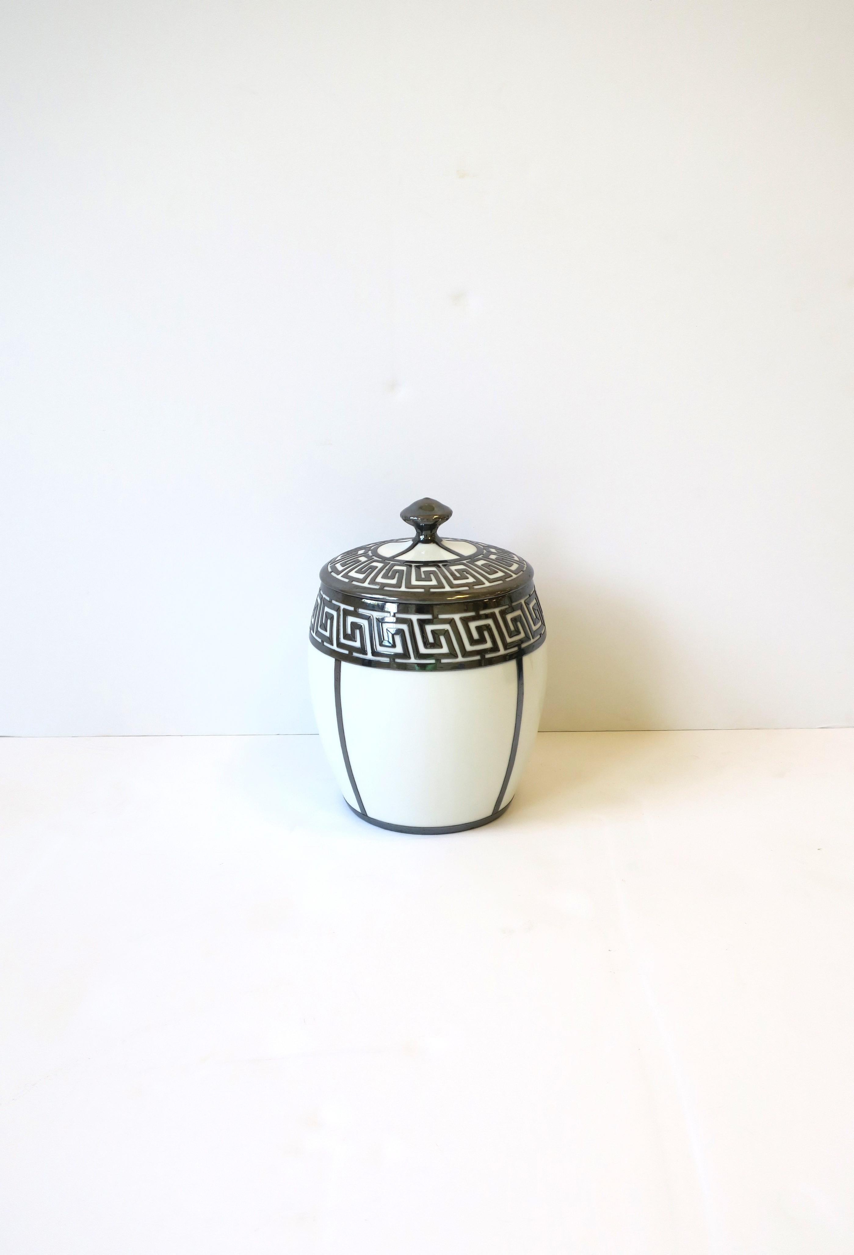 A beautiful French white and silver ice bucket with Greek-Key design, by Tressemann & Vogt, circa early to mid-20th century, France. Piece was made expressly for R. H. Macy & Co. New York, New York, as marked on bottom. R.H. Macy and Co. was founded