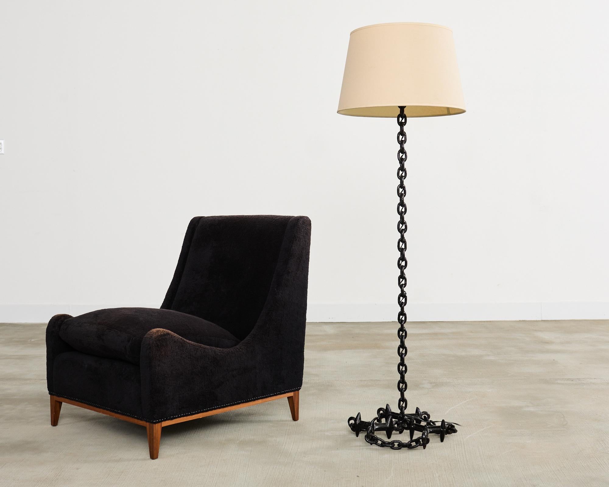 Spectacular 20th century French patinated iron chain link floor lamp in the iconic manner and style of Franz West. The lamp features a welded column of large 2 inch nautical chain links in the industrial brutalist style. The column is supported by a