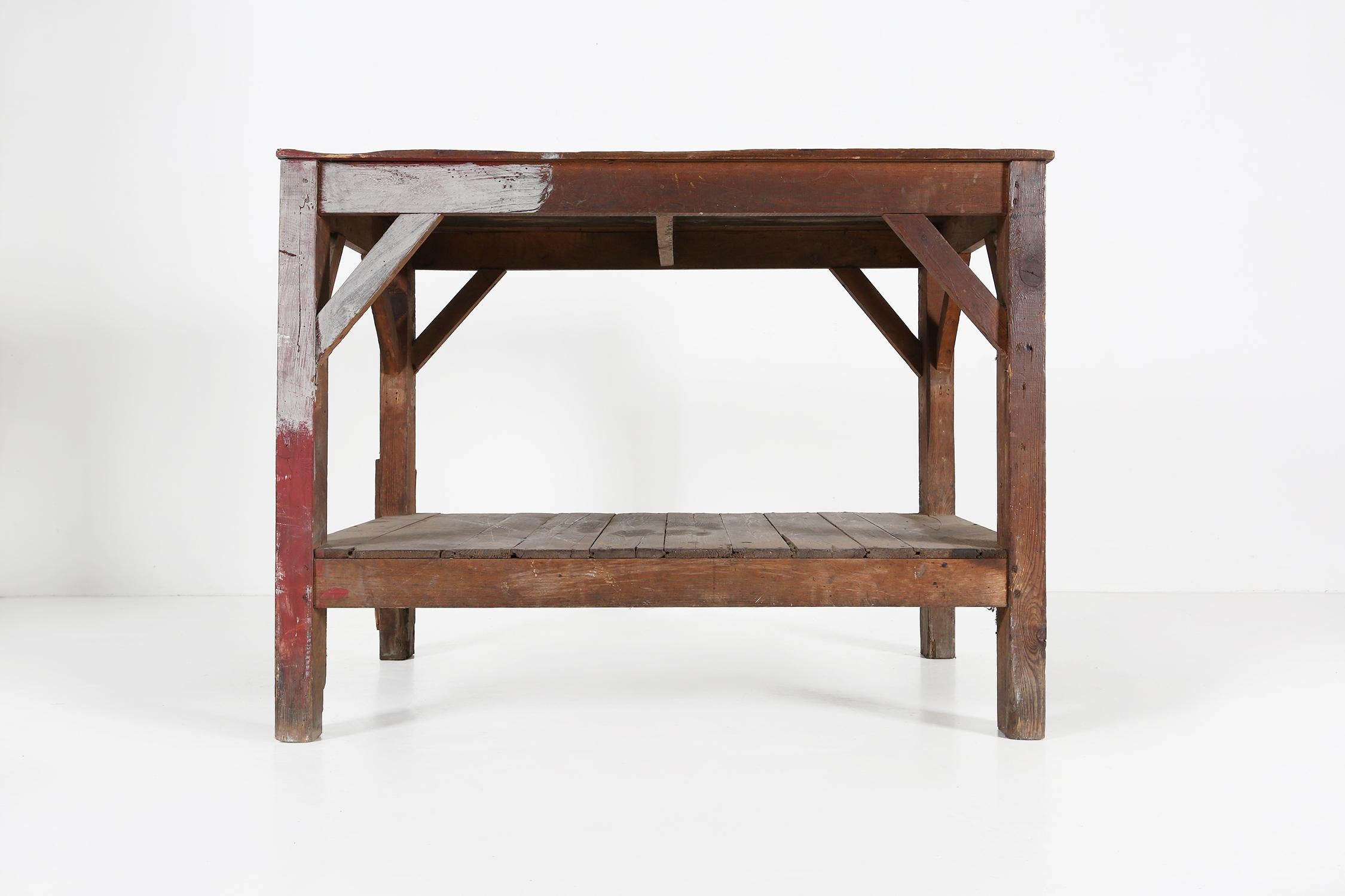 France / 1920 / Console table / wood / Vintage / Mid-Century / Industrial 

Industrial worktable or console table in solid wood with a great patina and old layers of paint. Crafted in France around 1920. This robust table has a sturdy construction,