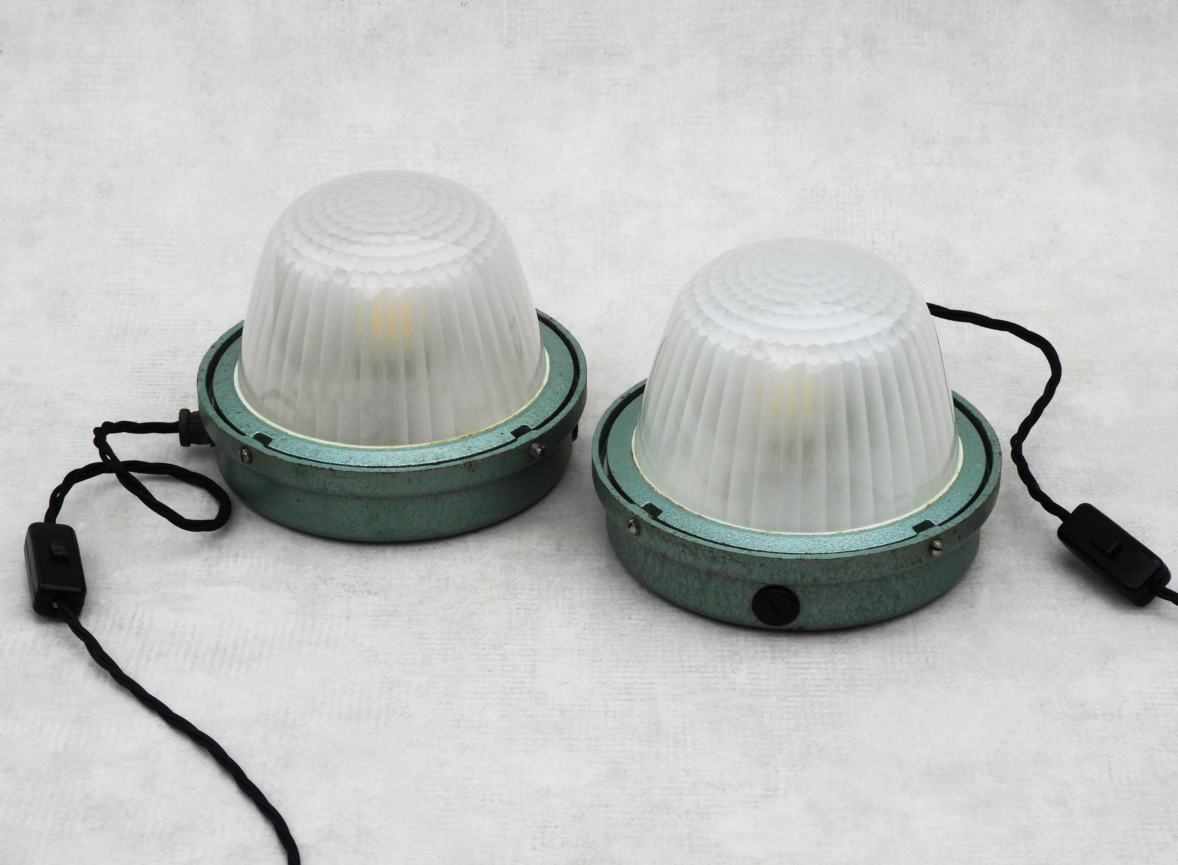 French Industrial Holophane lights c1950
Mid-century industrial light units from French lighting manufacturer Holophane c1950
Dome-shaped ‘Holophane’ glass diffusers set in cast metal casings with hammered metallic green paint finish. In good