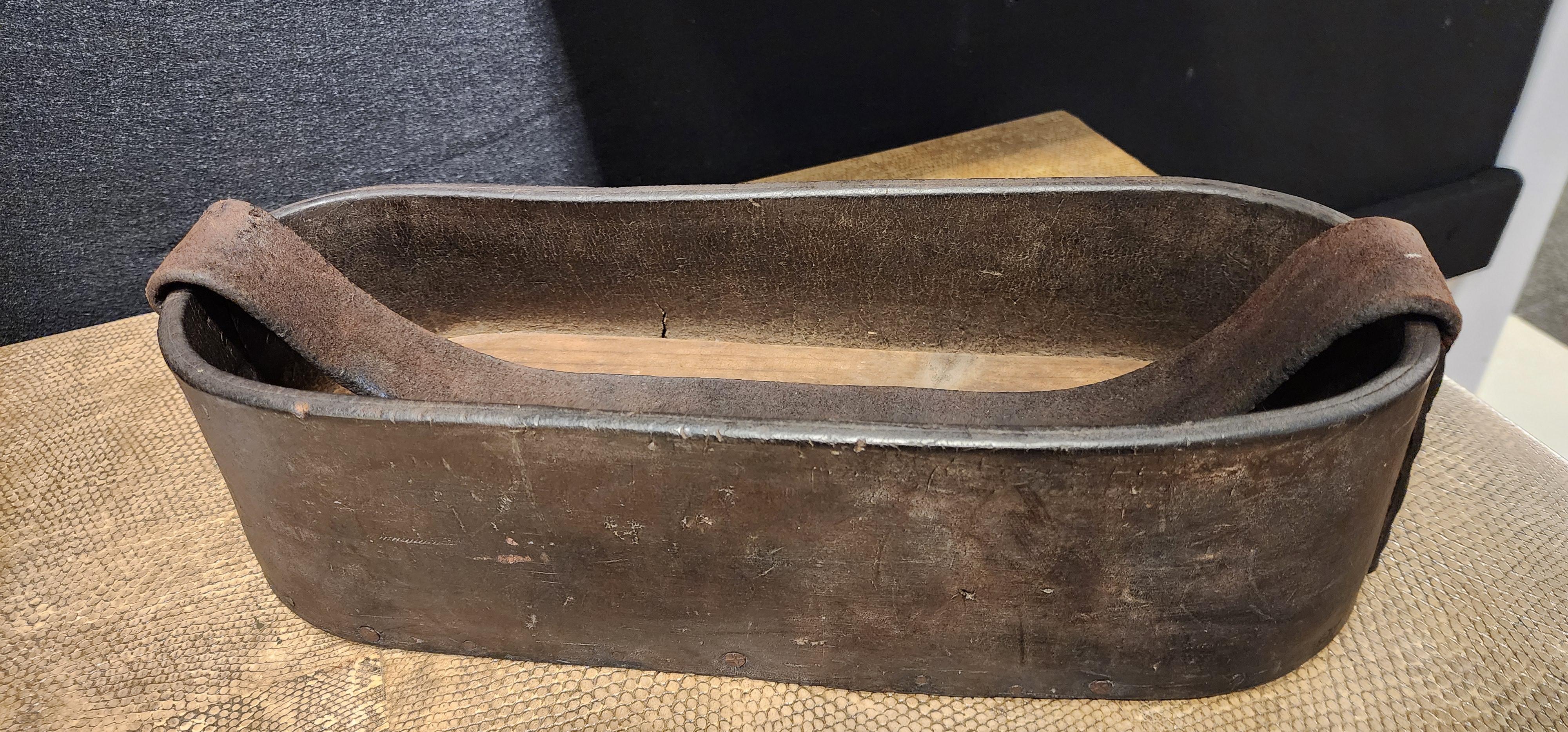 Handmade industrial leather tool caddy with wooden bottom. This chic industrial form is had made from thick oiled leather, with a wooden base. 
This would be great as a drinks carrier. 
France, 1920's.
This item can be viewed at the Berkshire