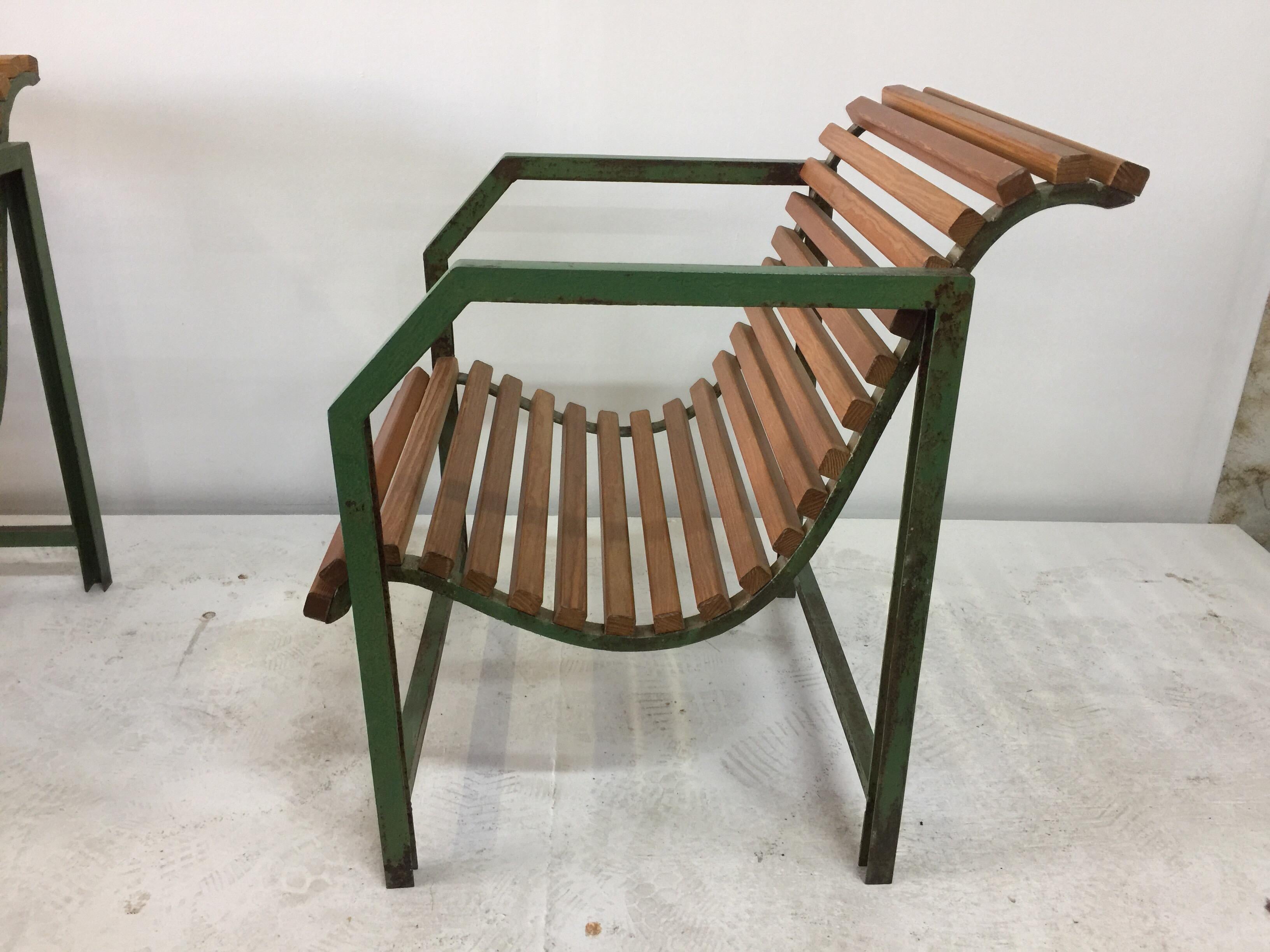 Wood slays and aged green painted metal - these geometric style industrial armchairs are chic and very comfortable.