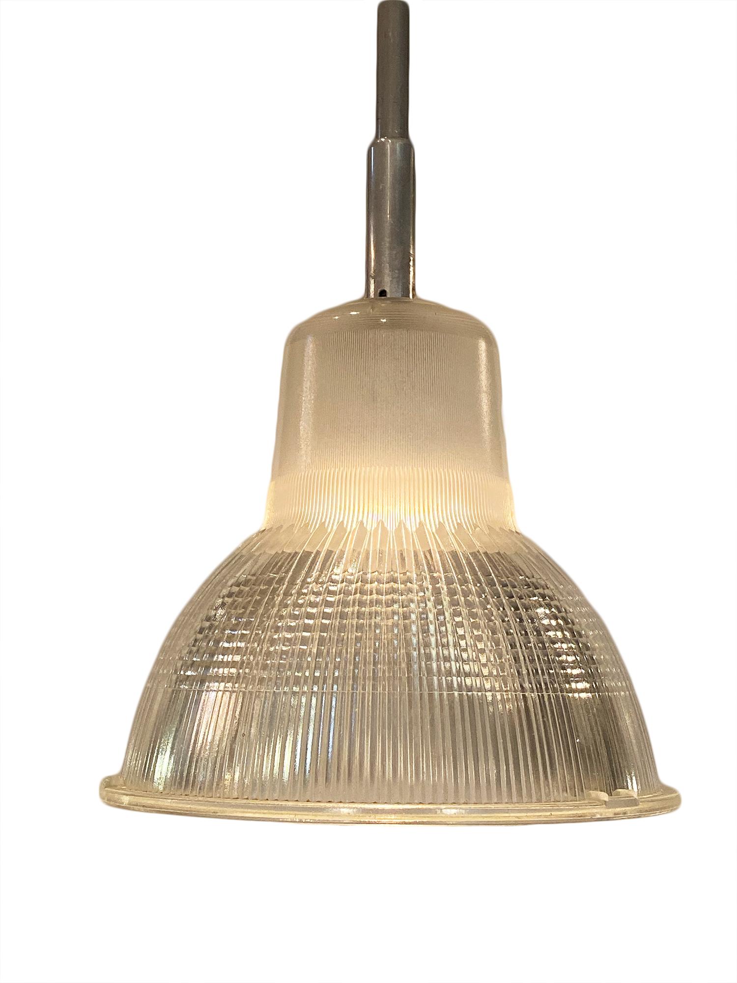 A unique set of French industrial pendant lights of glass and aluminum. We have three pairs available, each priced at $2400. They have been newly wired to fit US standards.