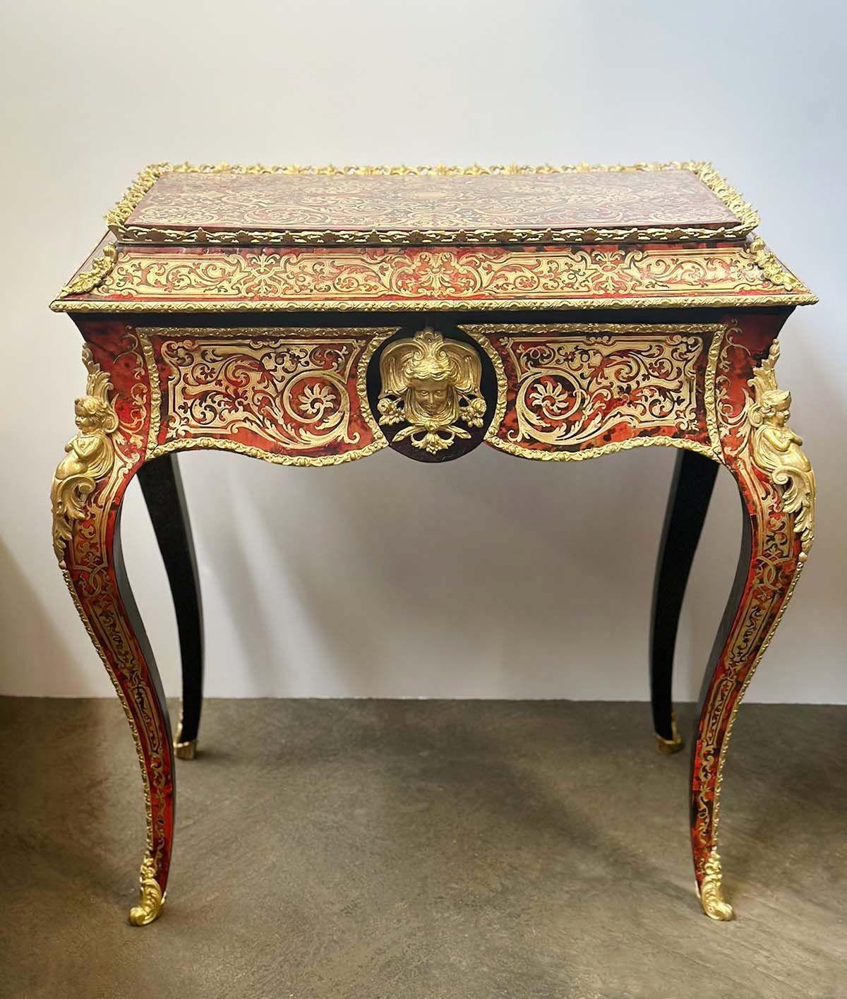 French Inlaid Boulle style jardiniere table converted into a vanity table. Beautiful brass gallery and inlaid all around the piece, accompanied with gilt brass putti mounts and a female head figure upfront.
Dimensions:
29.5