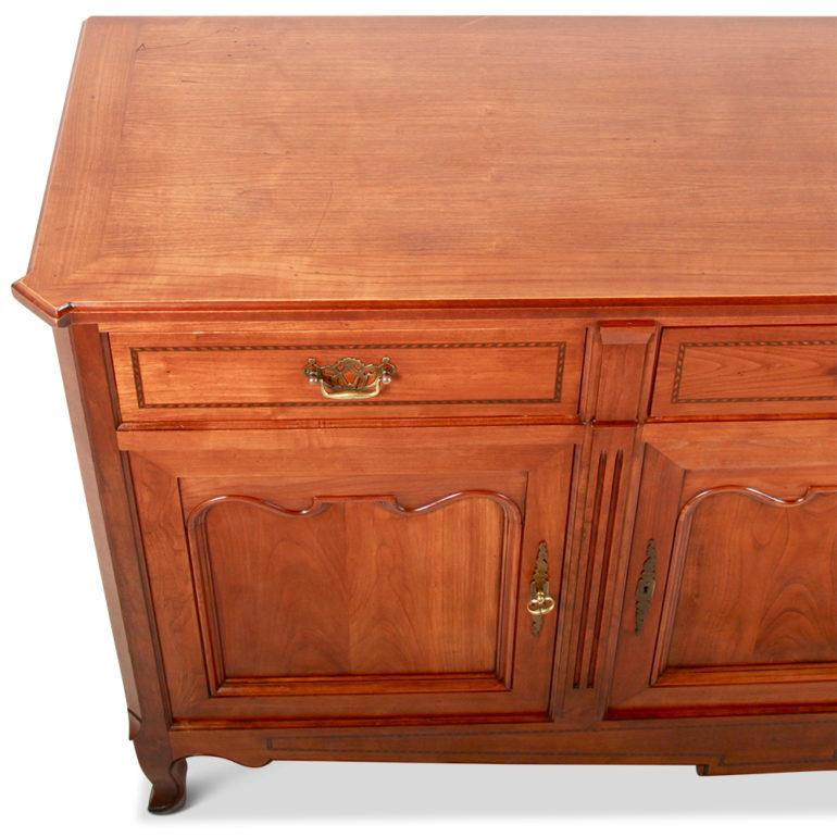 An inlaid cherry buffet with ample storage areas for linen, china, etc. Lovely marquetry accents around the drawers and brass pulls contribute to the overall beauty, circa 1940.



 