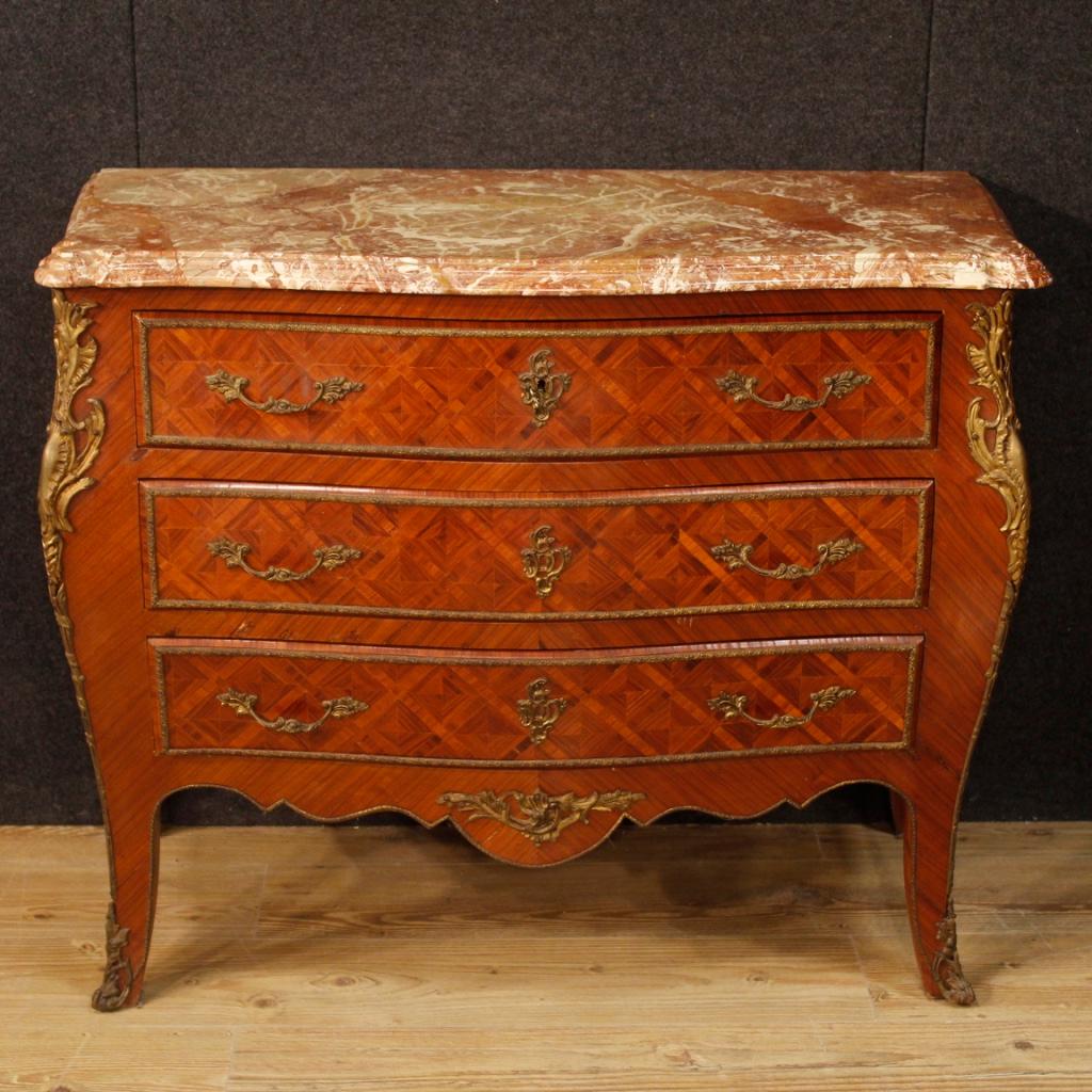 French dresser from 20th century. Furniture moved and rounded in Louis XV style with geometric inlay in mahogany and rosewood. Commode with three drawers richly decorated with gilded and chiselled brass and bronze decorations. Top in original marble