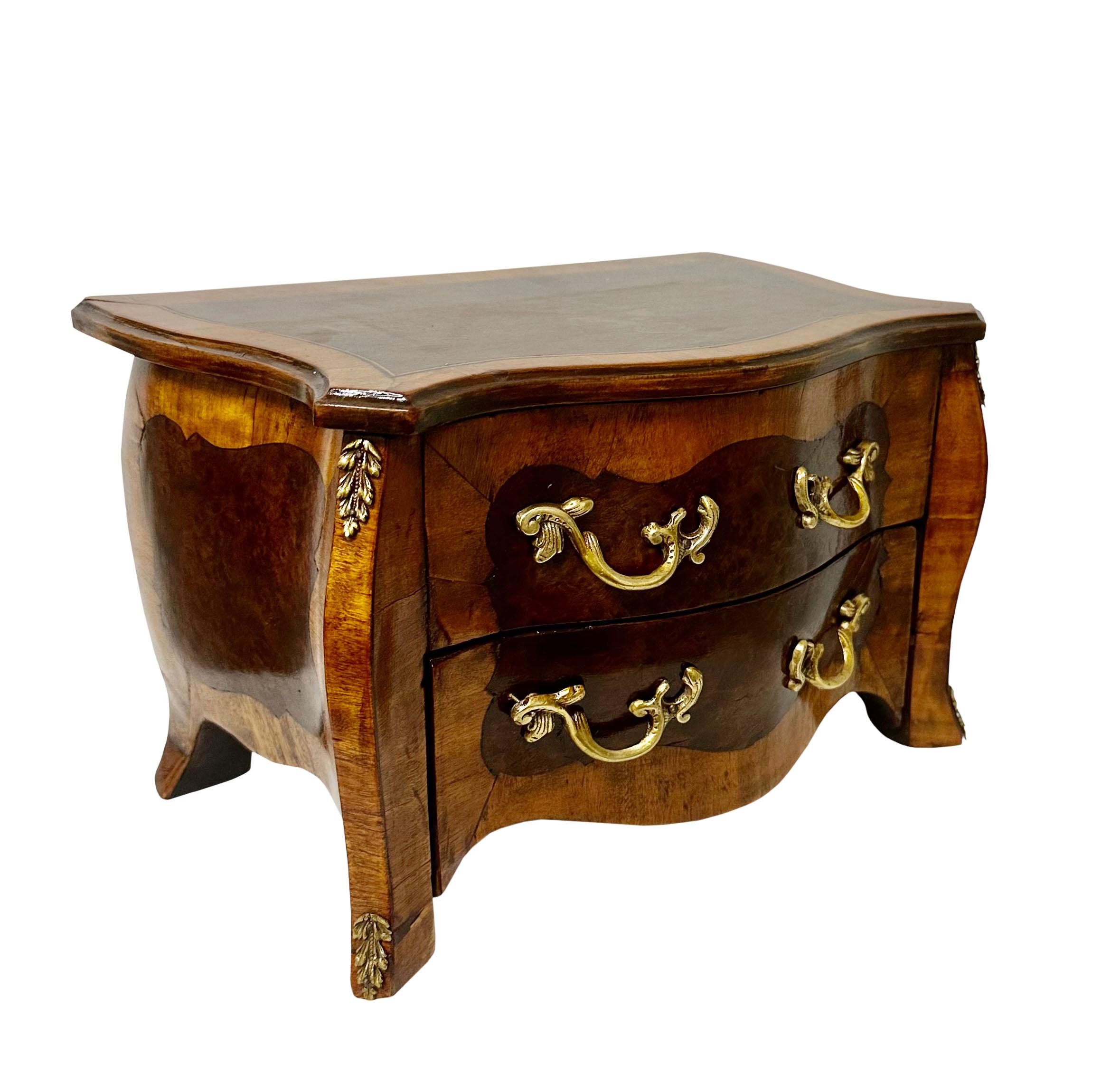 1800s French inlaid diminutive commode. It is a salesman sample converted into a jewelry box with the two deep compartments and back lined in velvet. The interior could have been made to use as a tea caddy as well. The first drawer does not work of