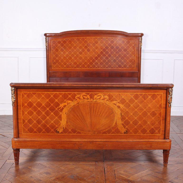 French inlaid satinwood Louis XVI style queen size bed, featuring inlaid wreaths and ribbons on a parquetry background. 

Part of a complete French satinwood bedroom suite.





   