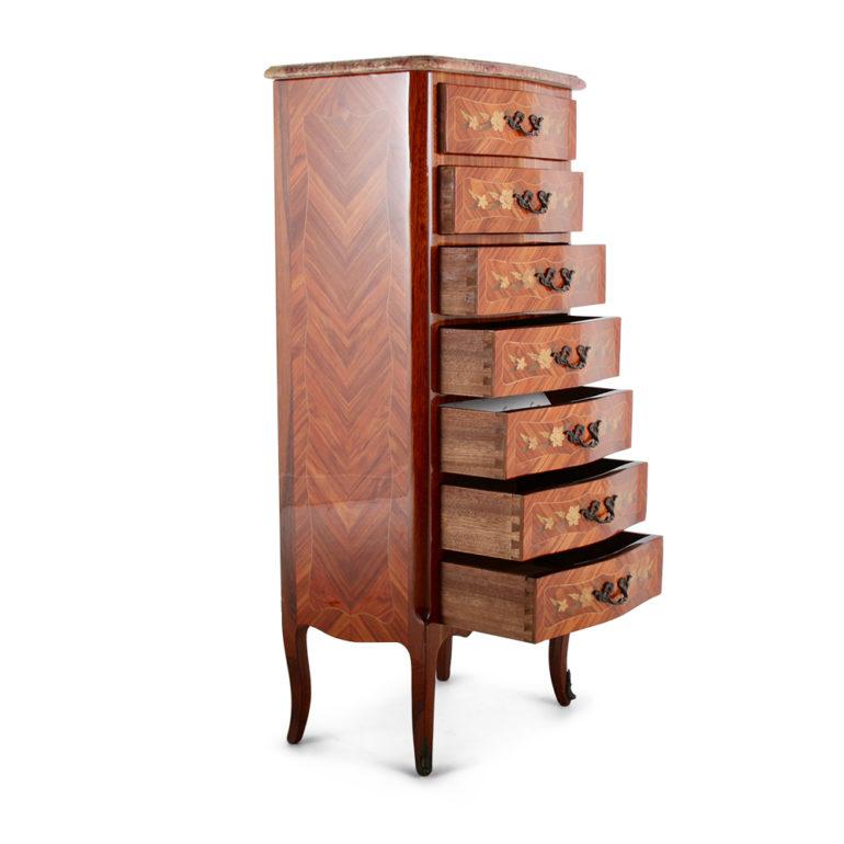 A beautiful seven-drawer semainier of outstanding quality, made of boxwood with floral inlaid marquetry, with brass accents and a lovely marble top. Its size makes it a perfect candidate for various locations throughout the home, circa 1950.



 