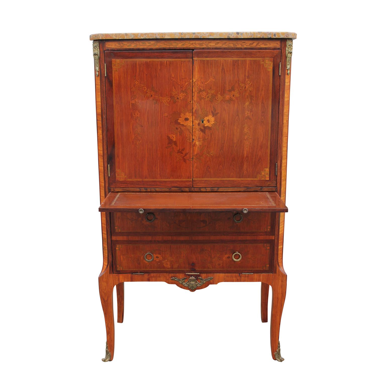 Antique inlaid kingwood secretary cabinet with a drop down bottom cabinet. The writing surface pulls out from under the top cabinet. Inside the top cabinet is a silk lined interior with a shelf. It has gold plated brass details.