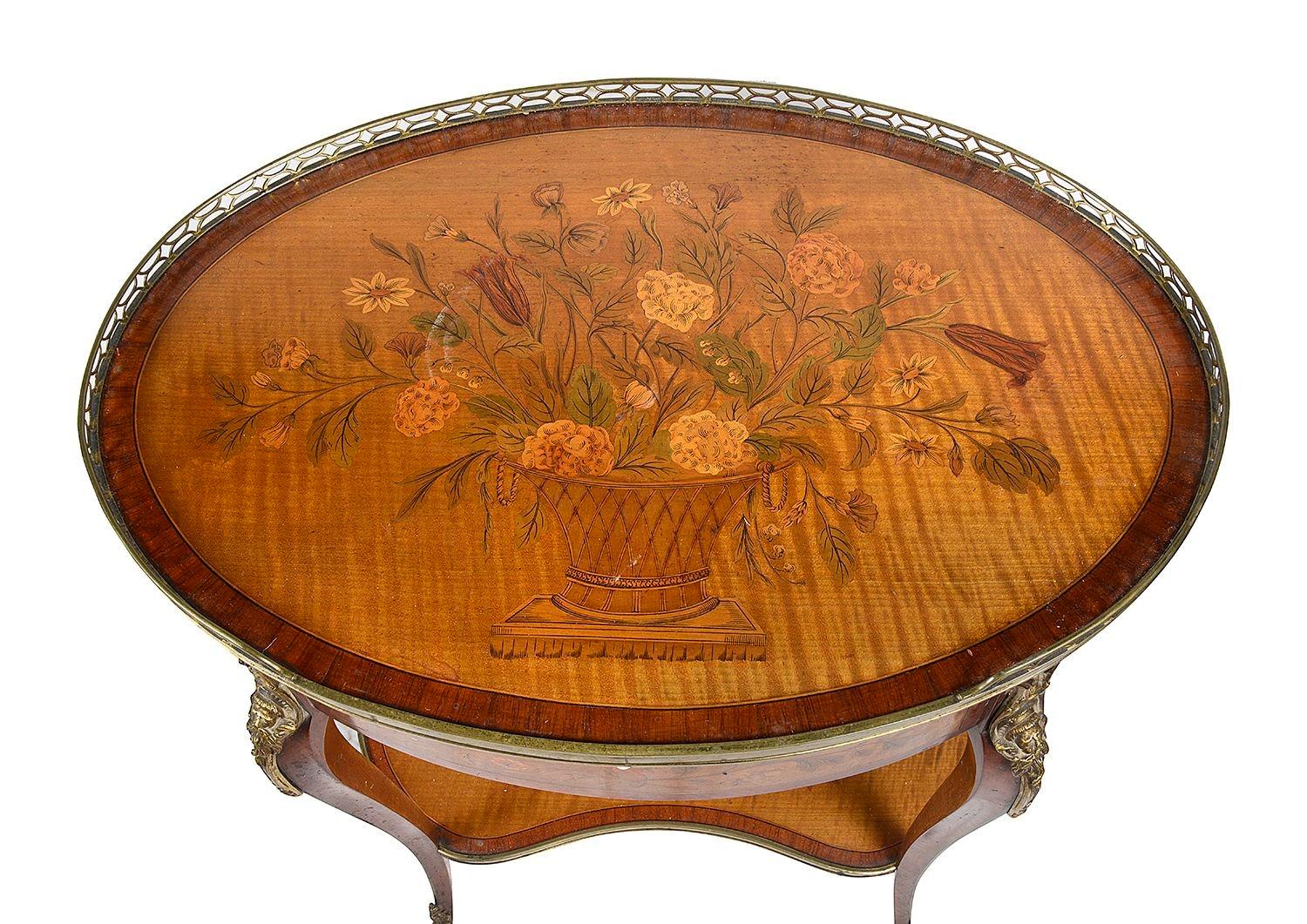 A very good quality late 19th Century French marquetry inlaid oval side table. The top having this wonderful inlaid basket of flowers, a brass pierced gallery, a candle slide and single frieze drawer. floral marquetry inlay to the frieze, elegant