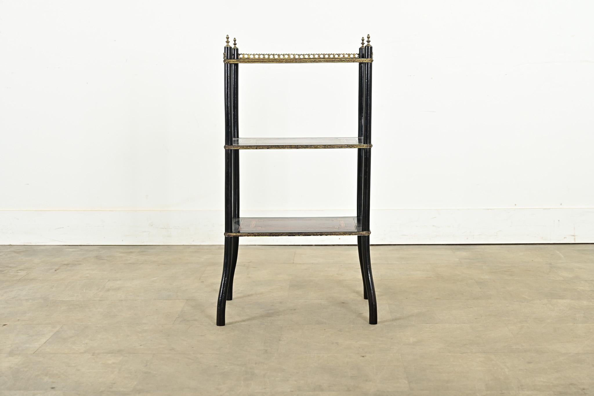 This extraordinary French etagere from the 19th century is marquetry art in furniture form. Each shelf is painstakingly inlaid with alternating patterns of ebonized and zebra woods, over bird’s eye maple to geometric precision. The top tier is