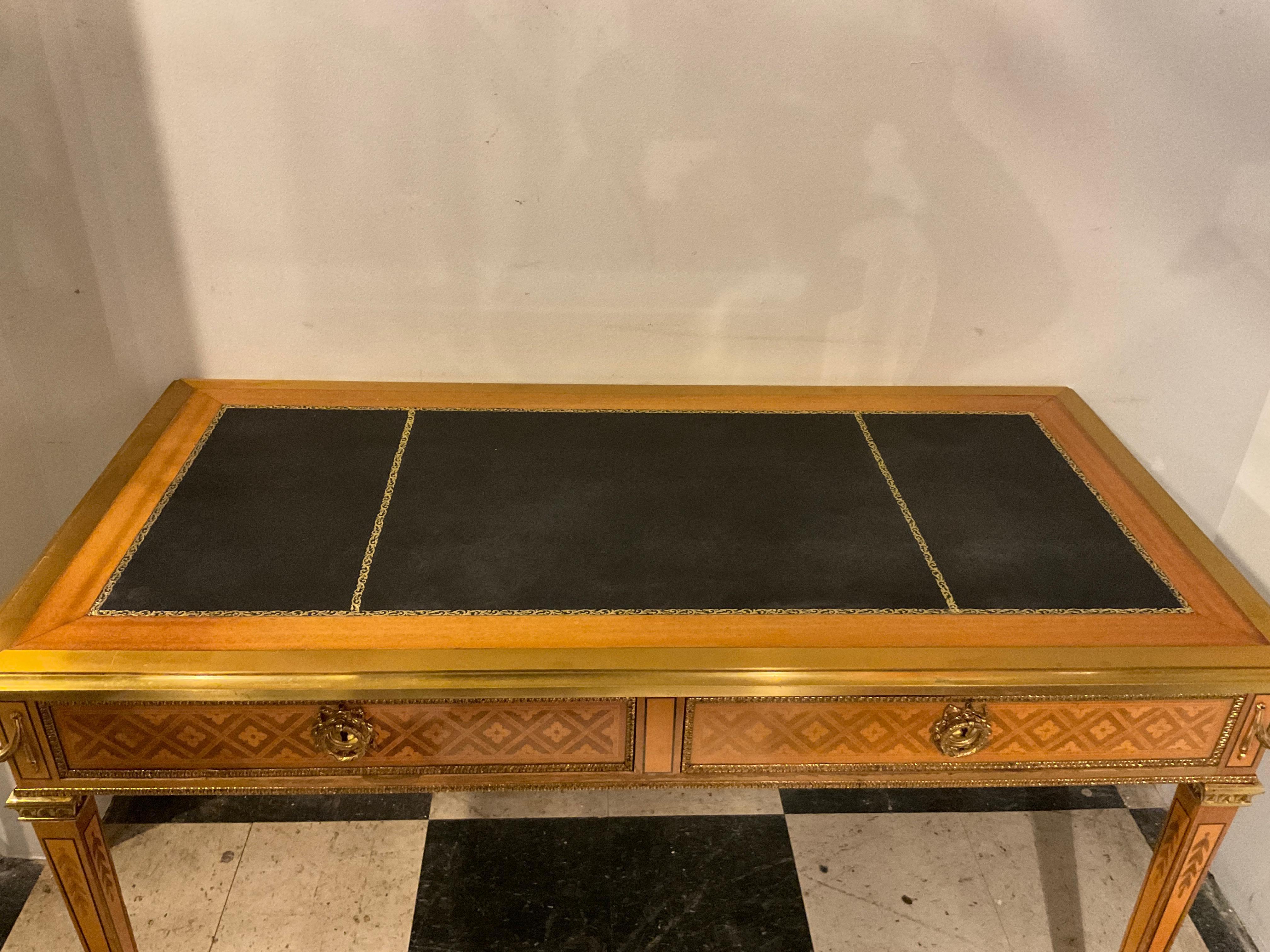 French Inlay writing desk with leather top. Finished on both sides. Back has 2 faux drawers. One front drawer is lighter then the other, as shown in image 9.