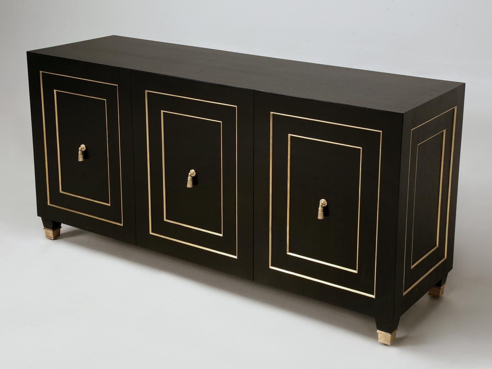 Louis XVI Style with a slight Mid-Century Modern twist. Our Old Plank buffet is made inhouse in our Chicago workshop and is available in virtually any dimension or finish you chose. Shown, is an ebonized mahogany with solid bronze trim and a Louis