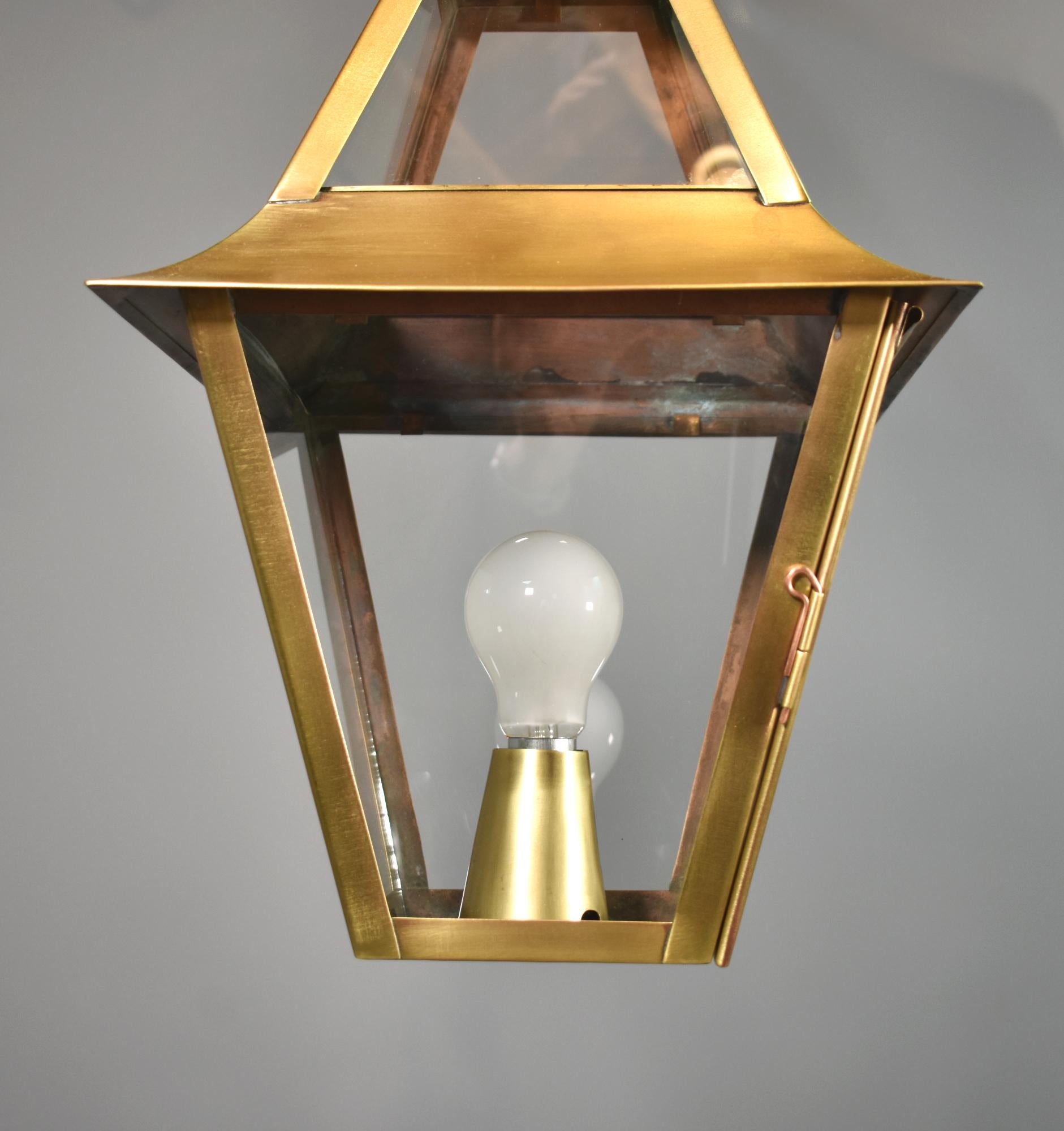 French Interior Brass Lantern Mansard Style

This large handsome brass hanging lantern comprises two section single glazed parts to allow maximum light.

It is hung from an adjustable brass chain fixed to a round pierced turret, that leads down to a