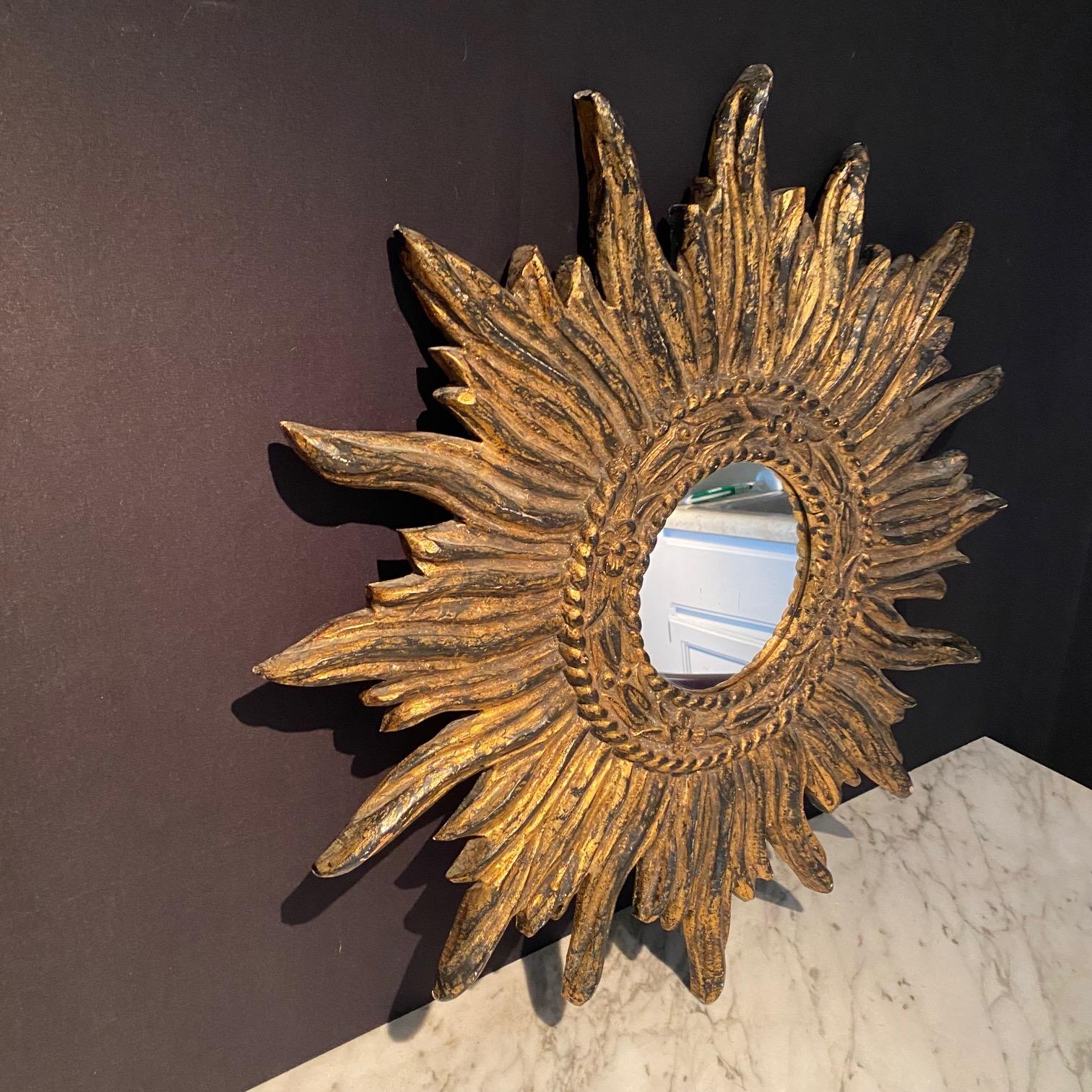  A very beautiful, intricate and decorative large golden soleil sunburst starburst giltwood convex mirror. Made and bought in France. Handmade of carved stunningly gilt-gold plated wood, in great condition. One of our favorites.   Mirror is 6.5