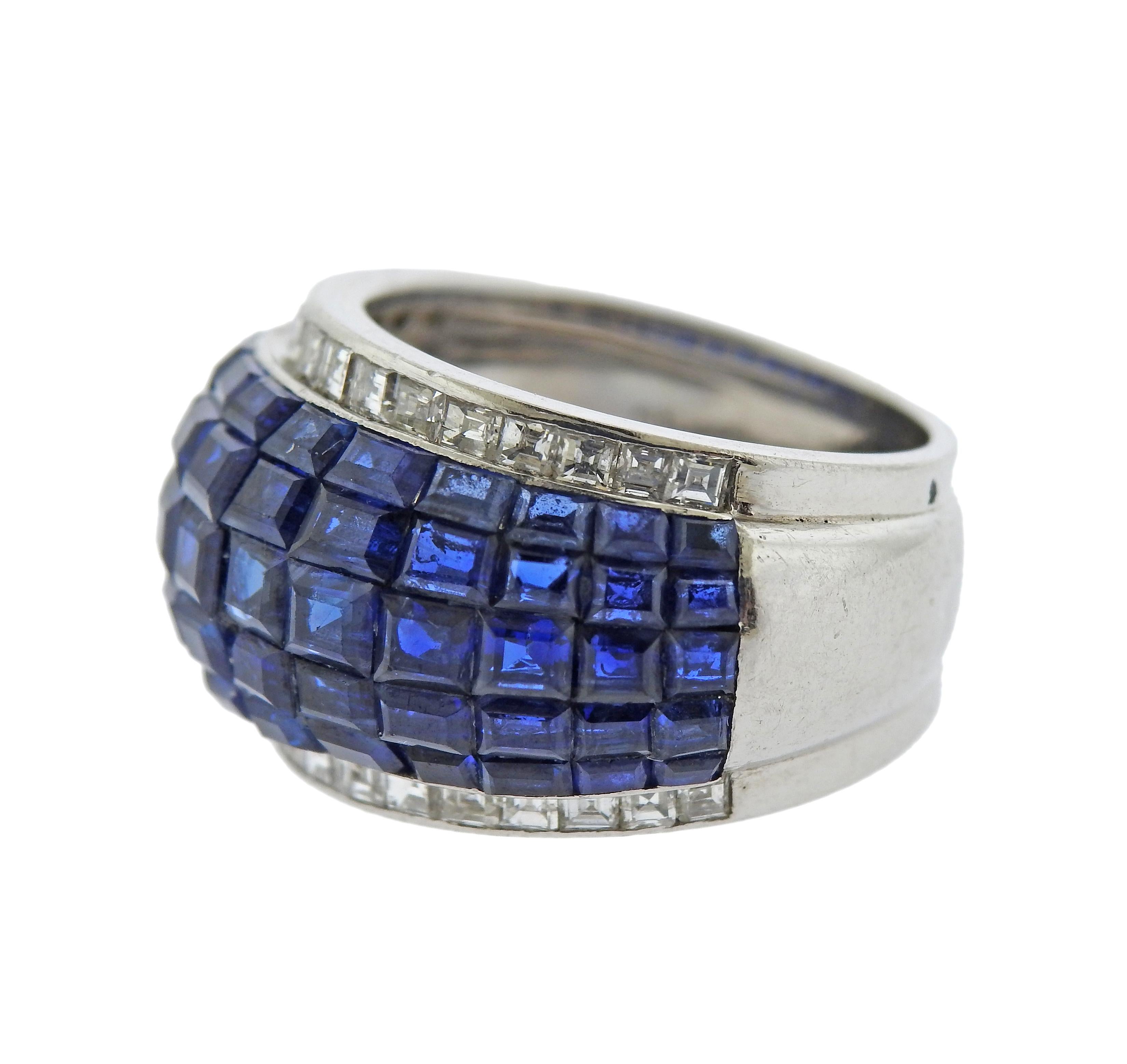 French made, platinum dome ring, featuring invisible set blue sapphires and approx. 0.60ctw in diamonds. Ring size - 6, ring top is 14mm wide. Marked: PT950, SC. Weight - 12 grams.