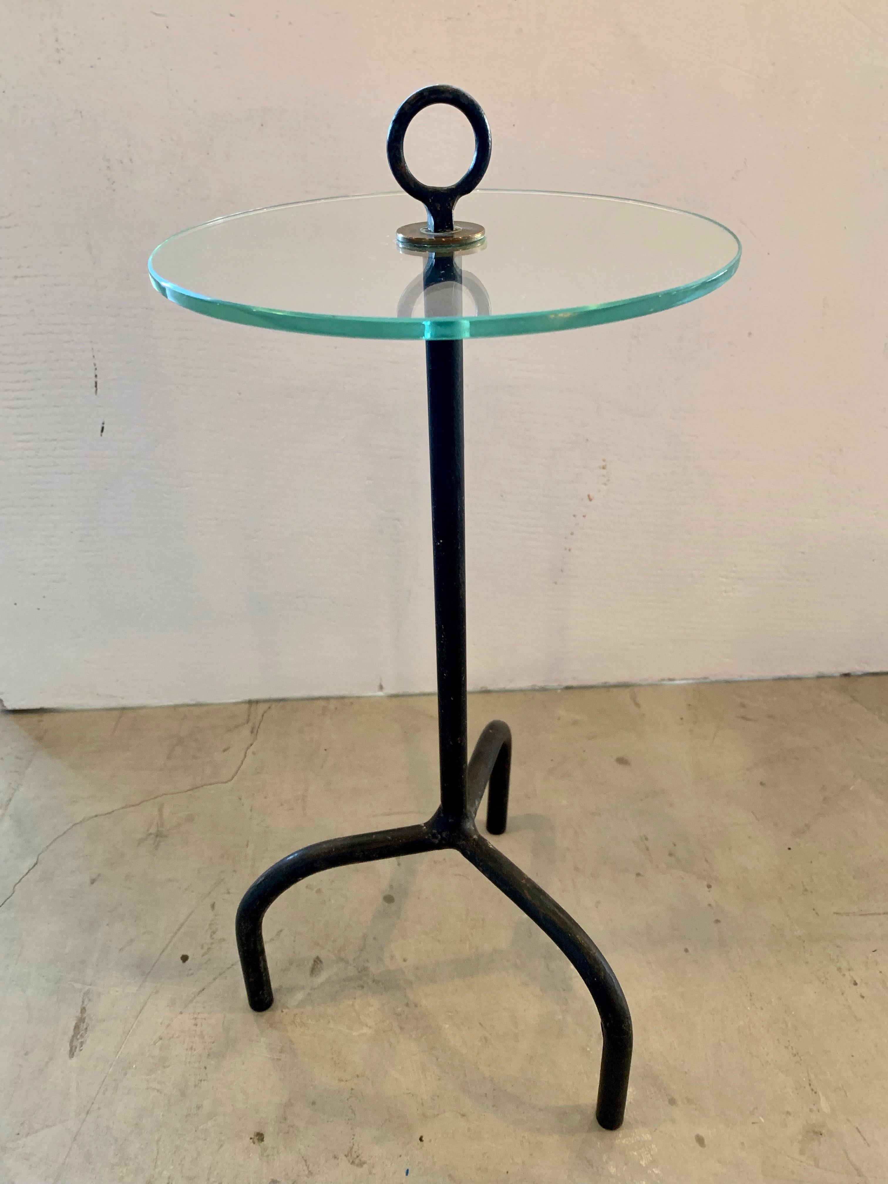 Classic French iron and glass cocktail table. Iron tripod frame with glass table and circular loop on top. Perfect petite table. Very good condition. 

Diameter of glass is just under 8