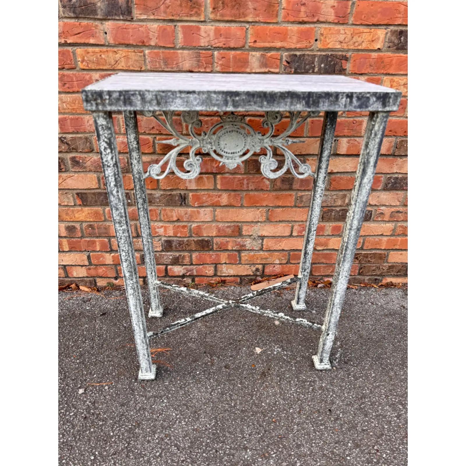 This beautiful custom made zinc finish console table features solid iron scroll work a marble top and is perfect for wherever a small table with height is needed. There is a pair  available. 

Dimensions
24.75ʺW × 13ʺD × 34ʺH
